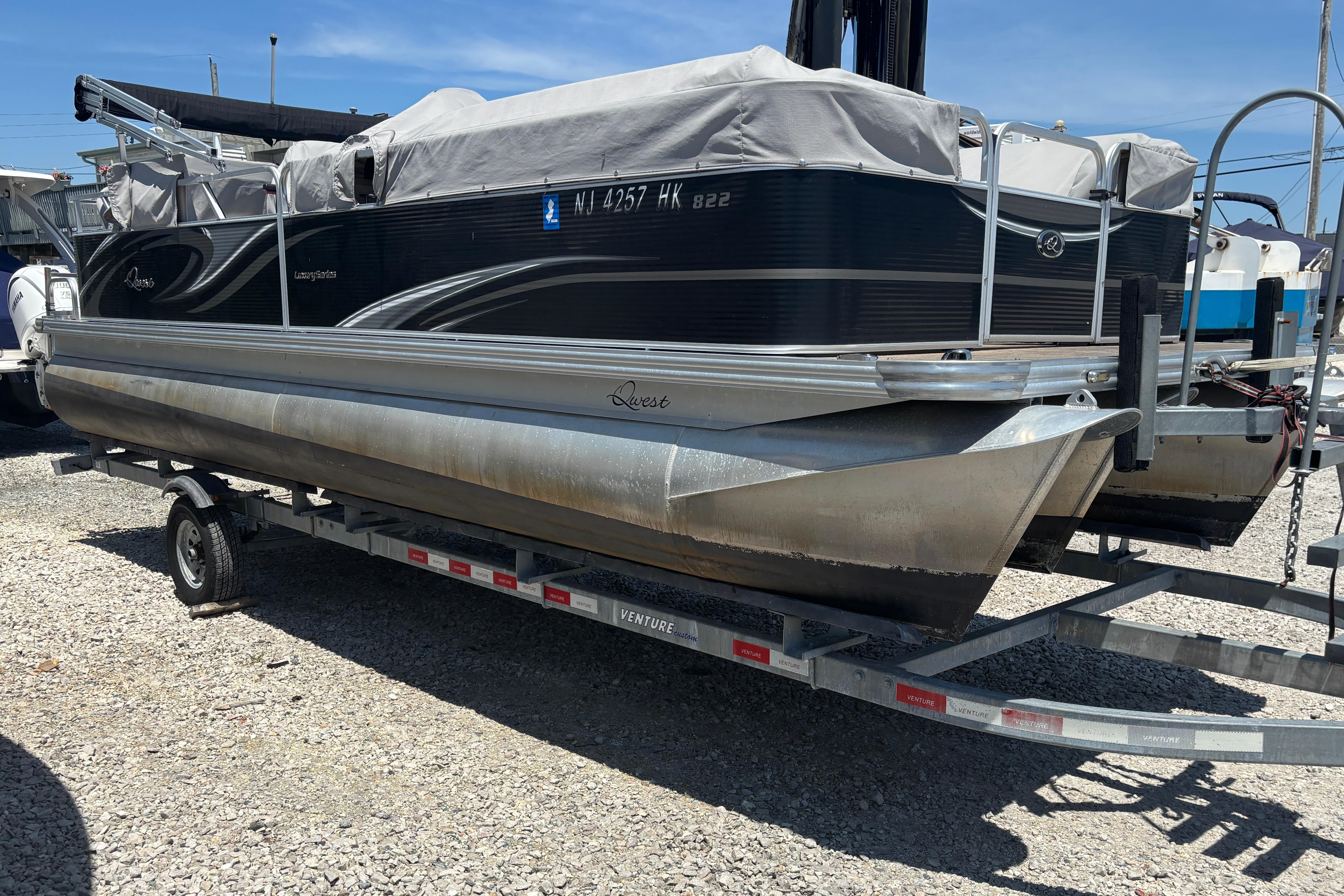 Pontoon boat Qwest LS 822 Bar 2017 on trailer, covered and parked outdoors.