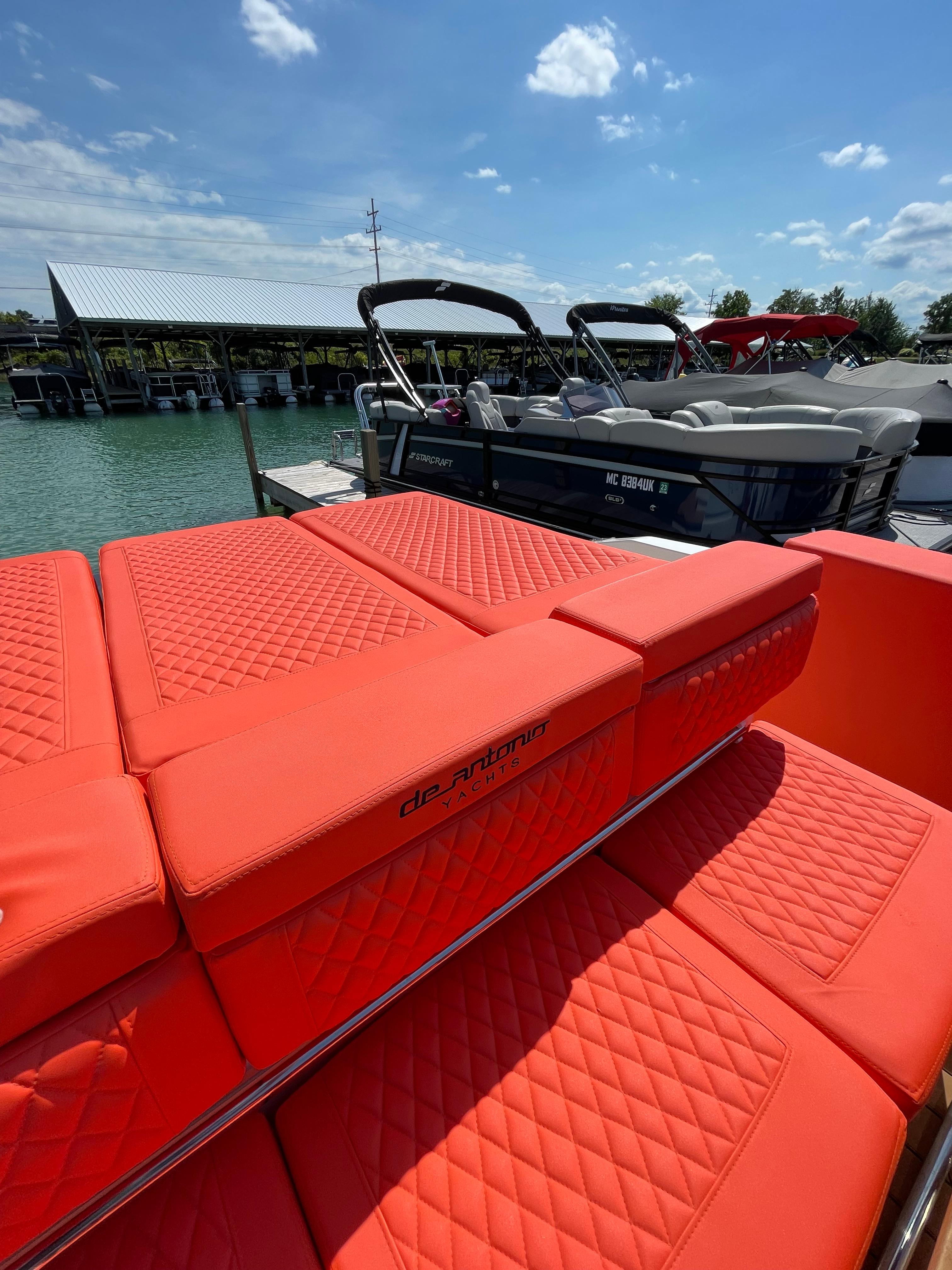 De Antonio Yachts D 28 2020 model with red quilted seating at a marina.