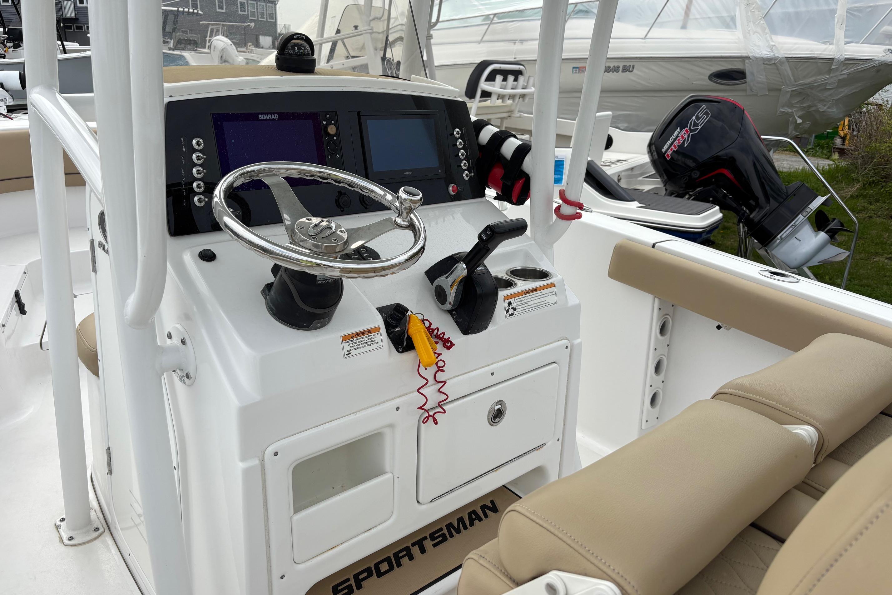 2018 Sportsman Heritage 231 Center Console boat interior with steering wheel and controls.
