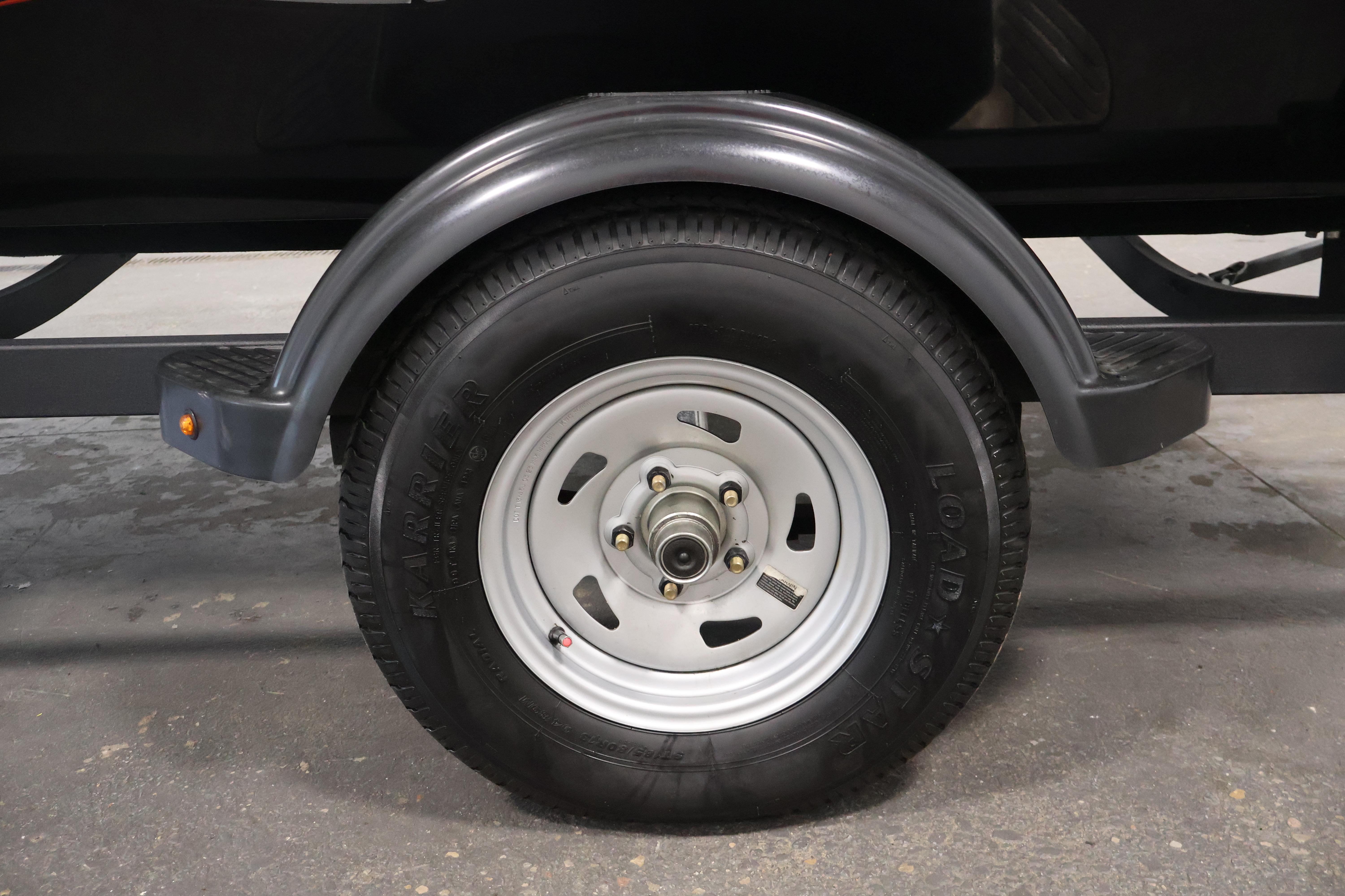 2024 Tracker Pro 170 trailer wheel with black tire and silver rim.