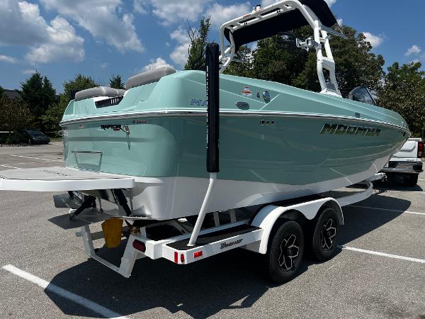 2025 Moomba Max boat on trailer in parking lot, sunny day.