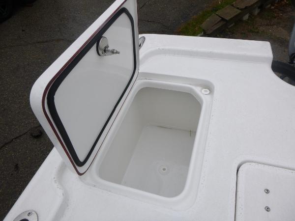 Open storage compartment on 2025 Sea Pro 250 Bay boat deck.
