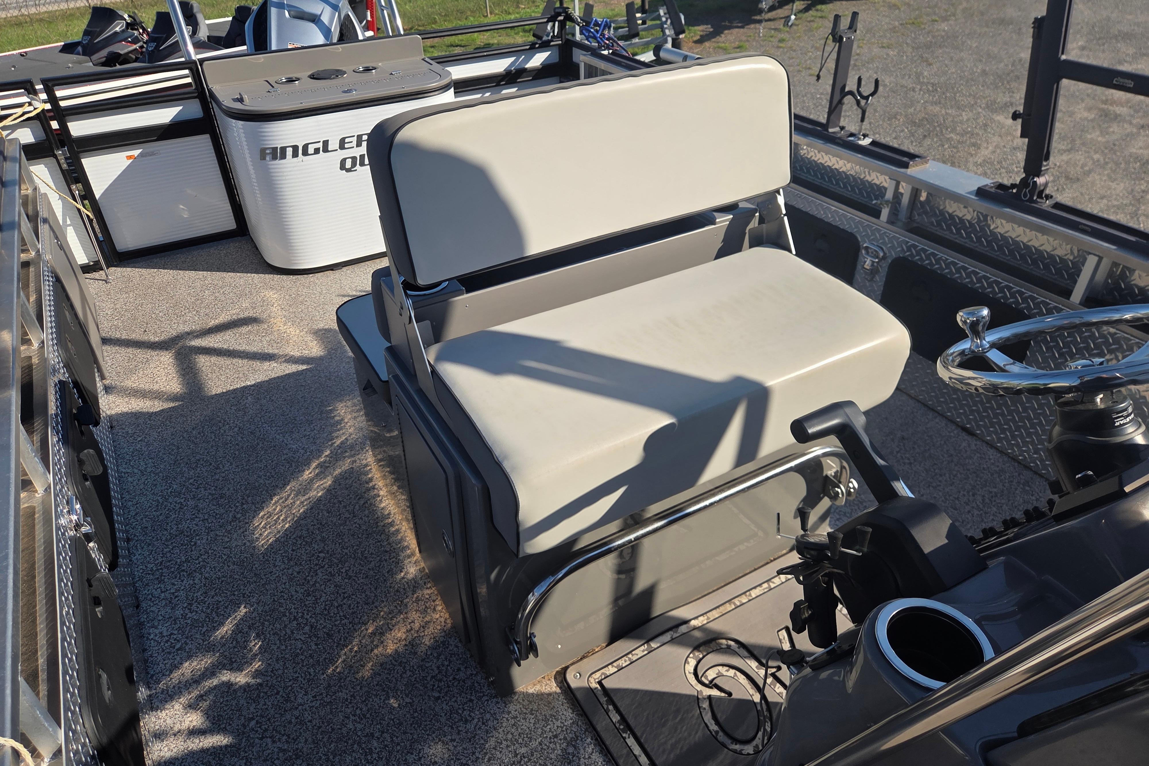 2024 Angler Qwest 8526 Pro Troll boat interior with seating and steering wheel.