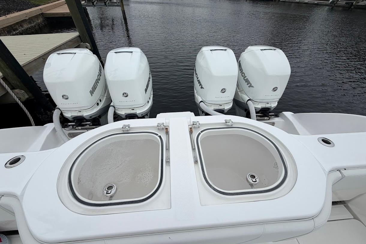 2019 Invincible 40 Catamaran with four Mercury outboard engines at dock.