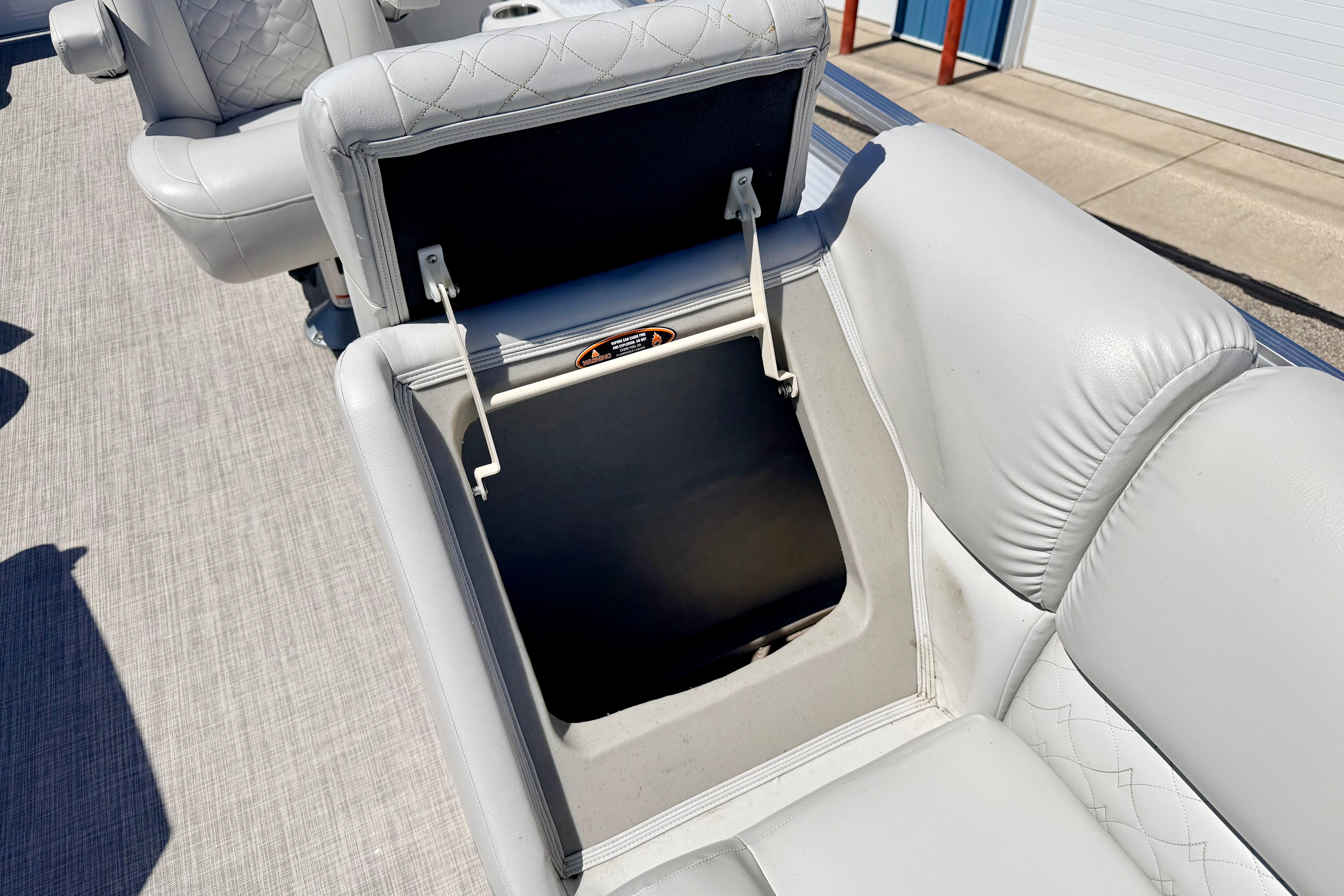 2019 Crestliner 240 Rally DX CW boat seat with open storage compartment, showcasing quilted upholstery.