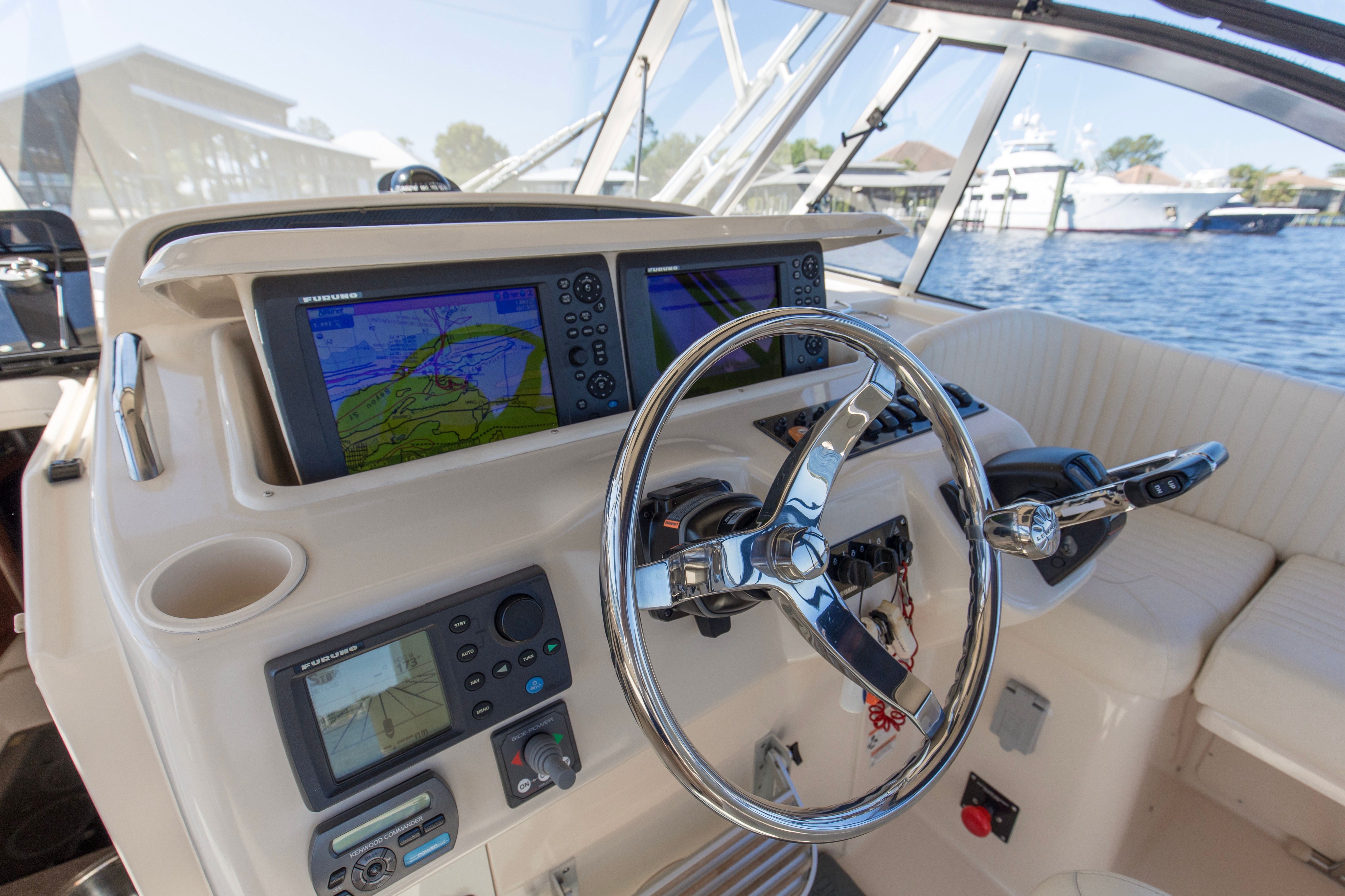 Helm of 2009 Grady-White Express 330 yacht with navigation screens.