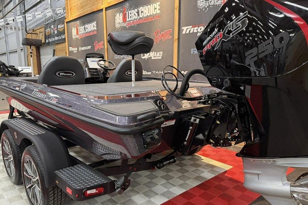 2026 Triton 20XP Patriot boat with Mercury Pro XS 250 engine in showroom.