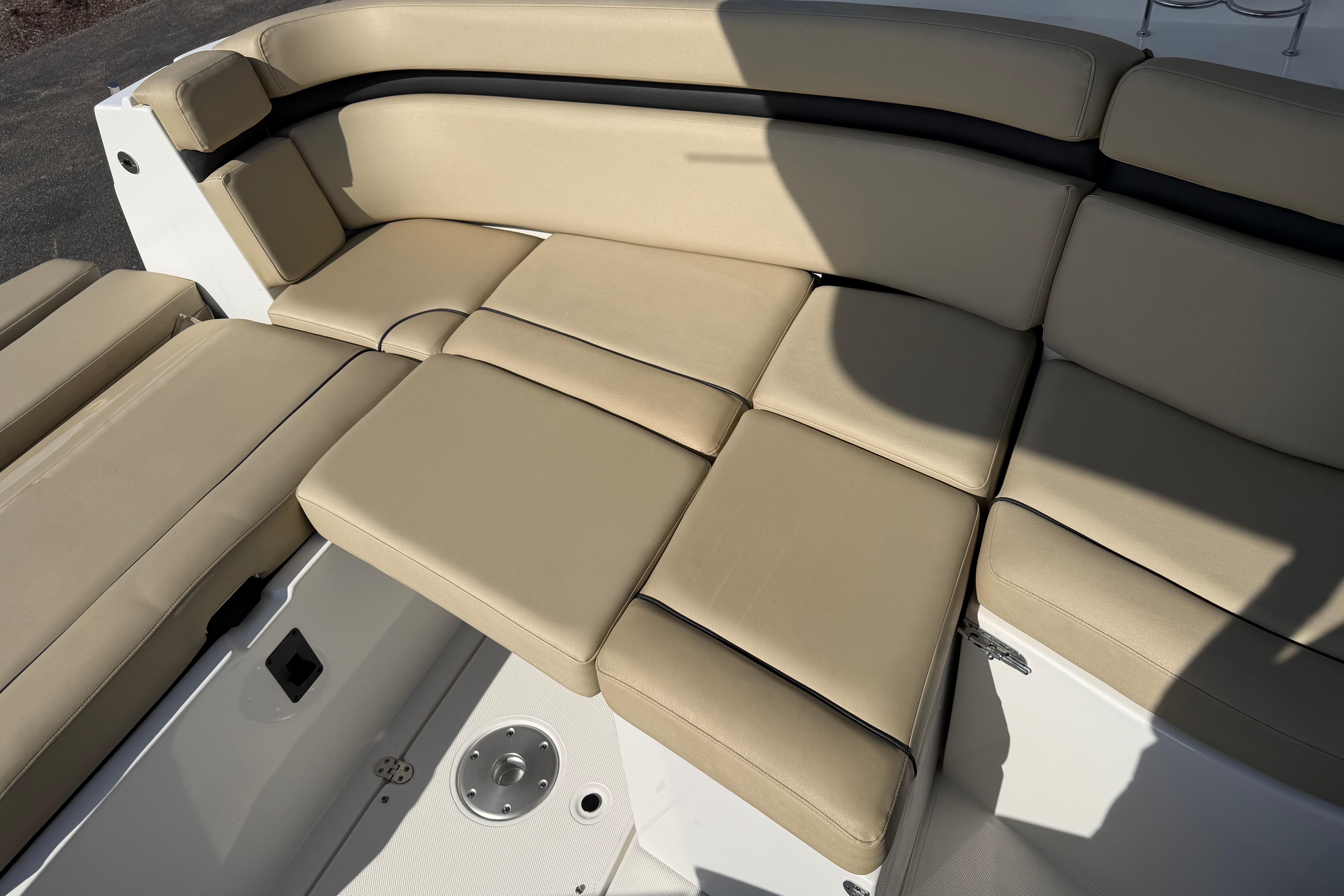 2019 Rinker EX 320 boat with beige cushioned seating area.