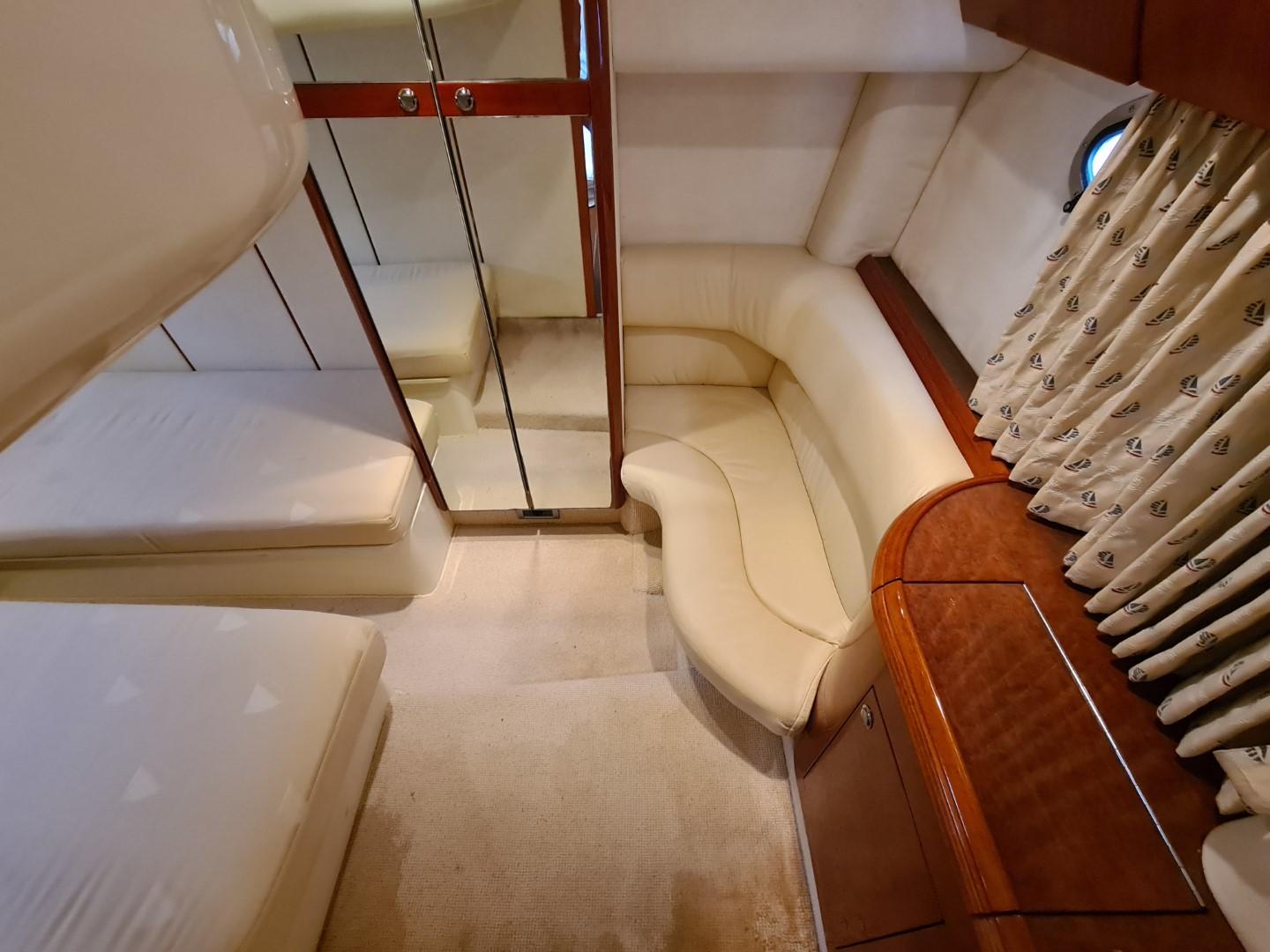 Luxurious interior of 2004 Fairline Targa 43 yacht with elegant seating and mirrored closet.