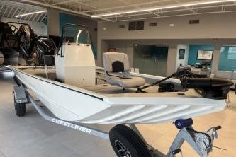 2026 Crestliner 1860 Retriever CC boat displayed in a showroom on a trailer.