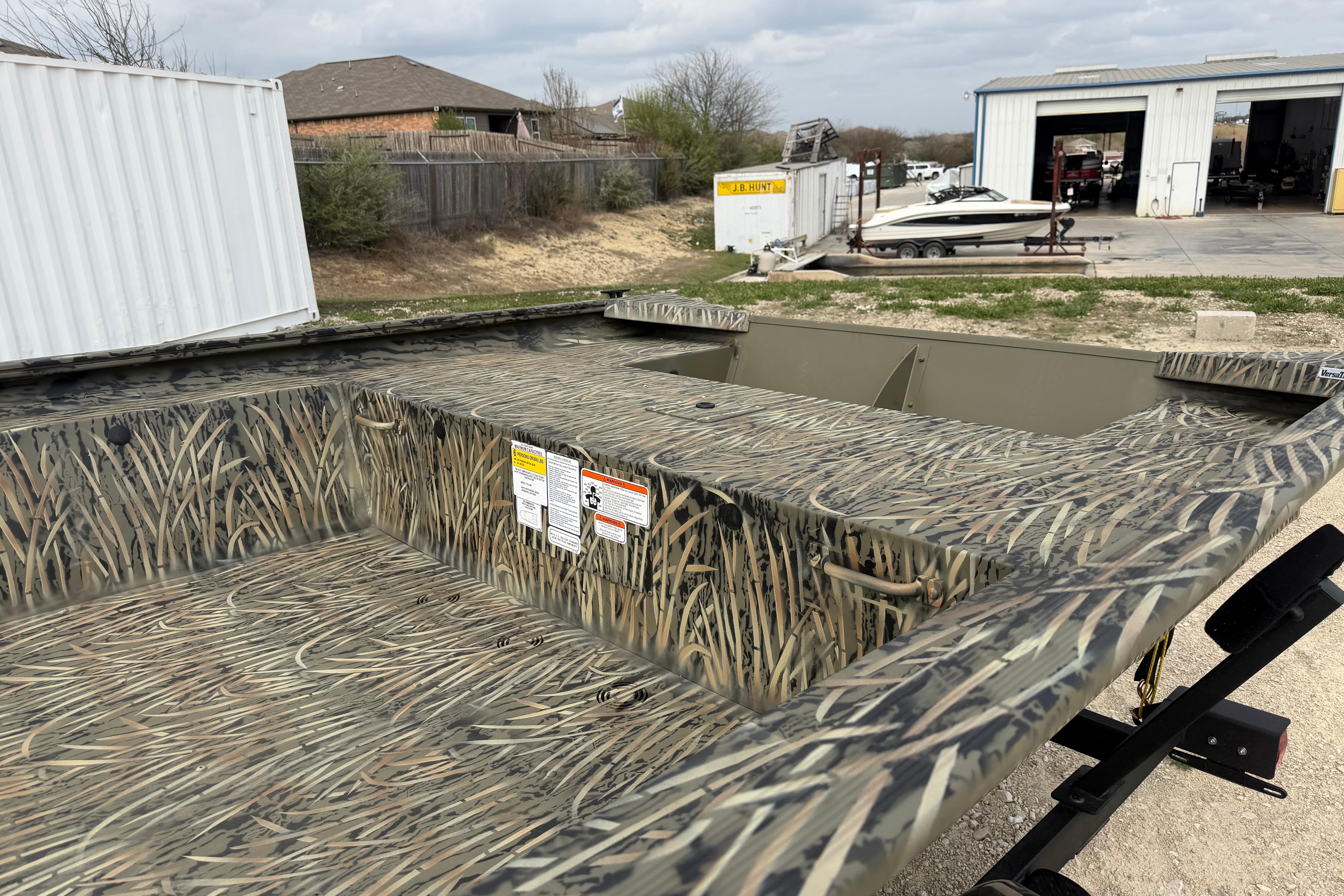 2026 Tracker Grizzly 1754 Utility boat with camouflage design in an outdoor setting.
