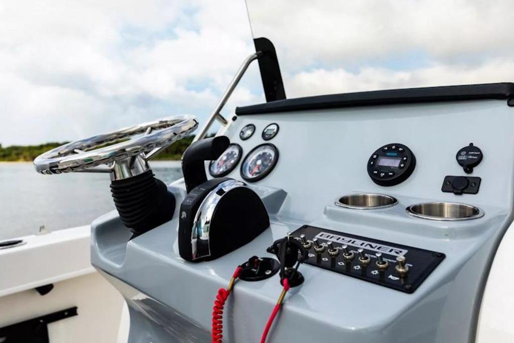 2026 Bayliner Trophy T20CC boat dashboard with steering wheel and control panel.