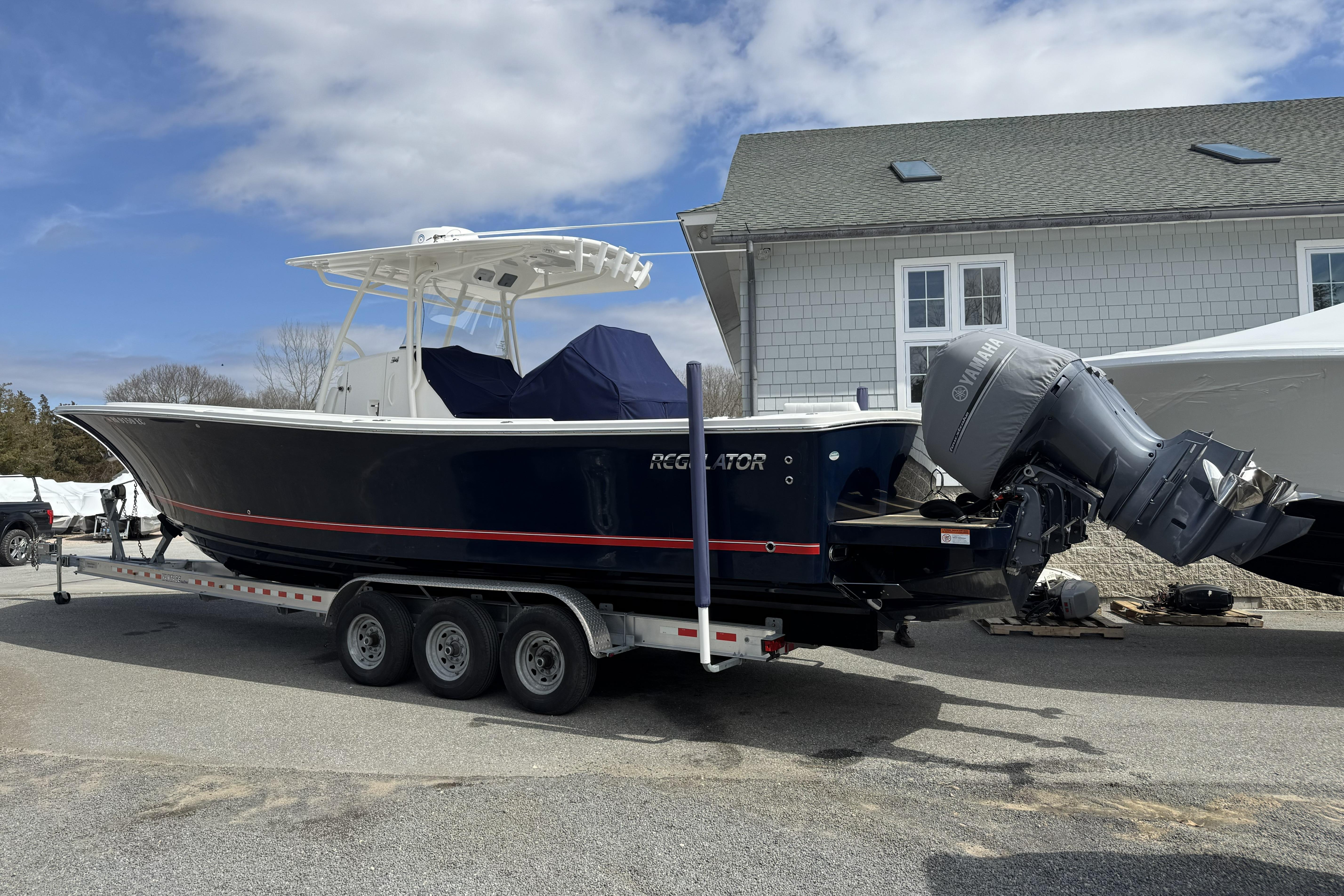 2018 Regulator 34SS boat on trailer, parked outdoors near a building.