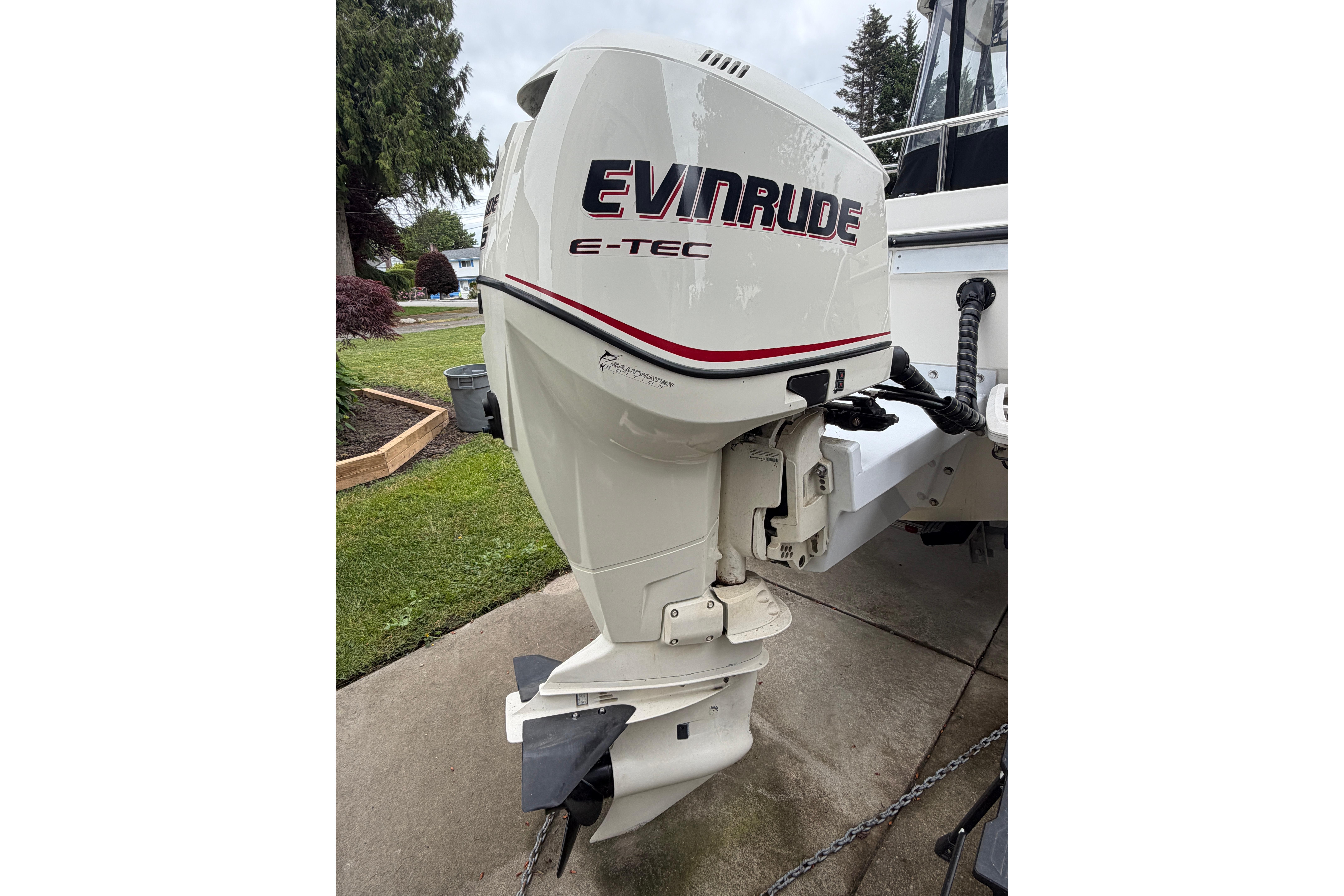 Outboard motor on a 2005 Bayliner 2052 Trophy Walkaround boat, featuring Evinrude E-TEC branding.