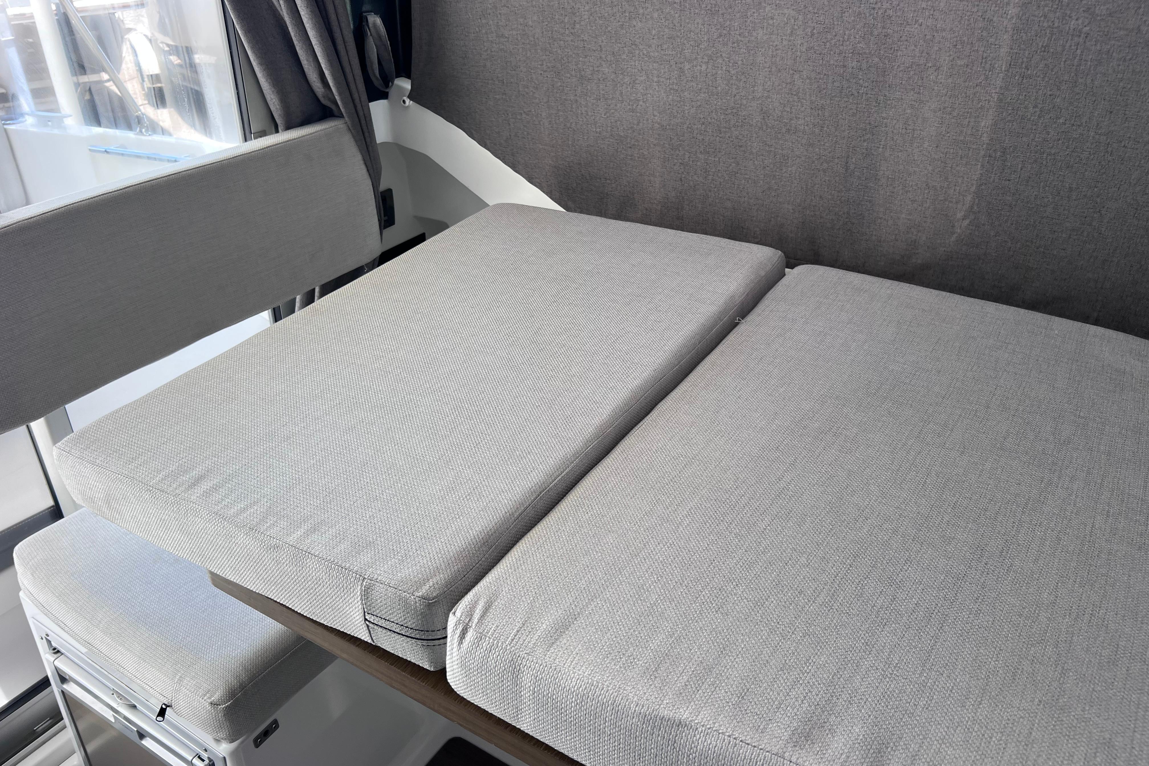 Interior seating of 2021 Jeanneau NC Weekender 795 Series 2 with gray cushions.