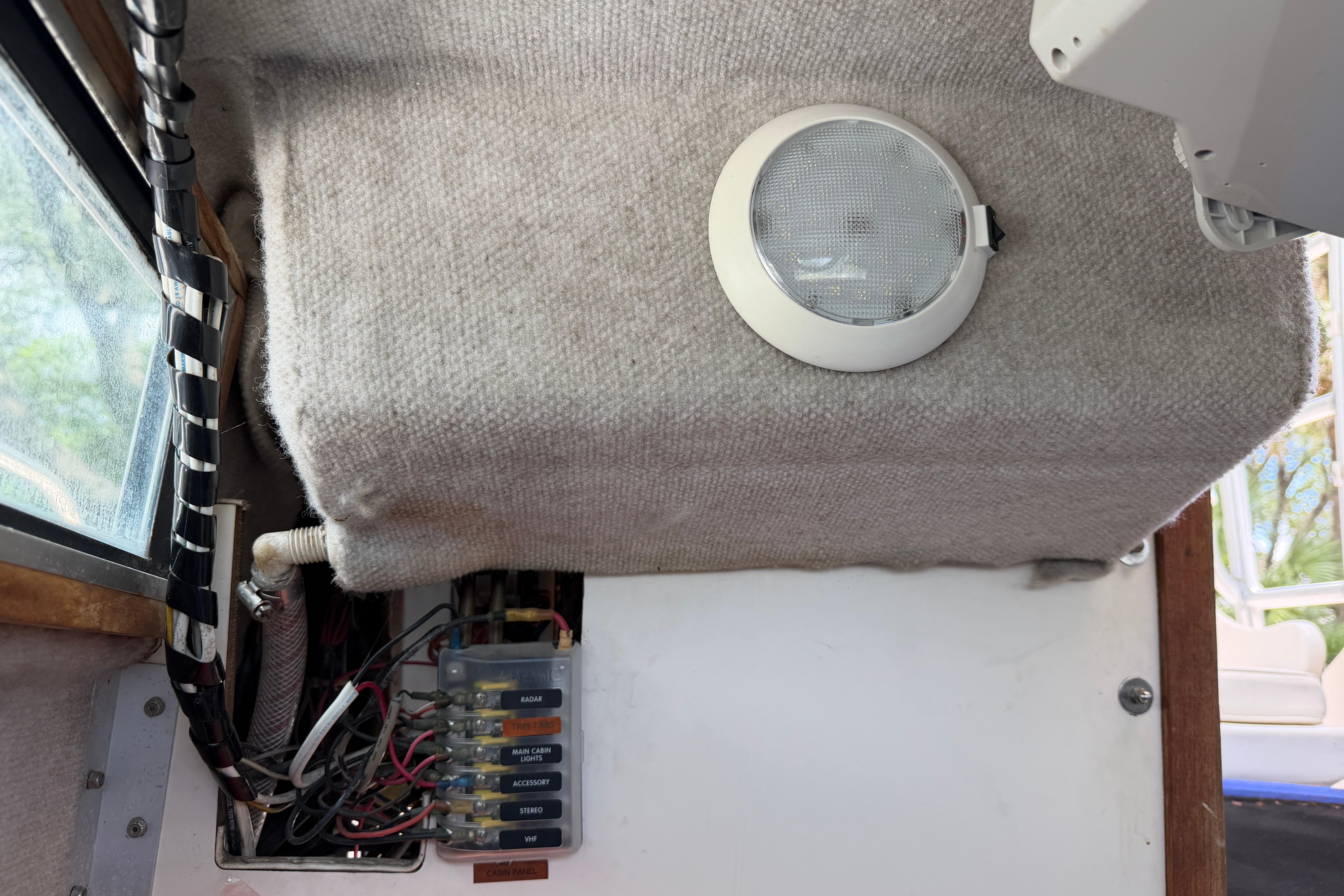 Interior view of a 1987 Grady-White Seafarer 226 boat showing wiring and a light fixture.