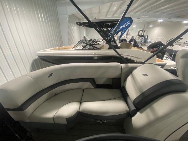 2024 Starcraft EXS 1 boat interior with beige seating in showroom.