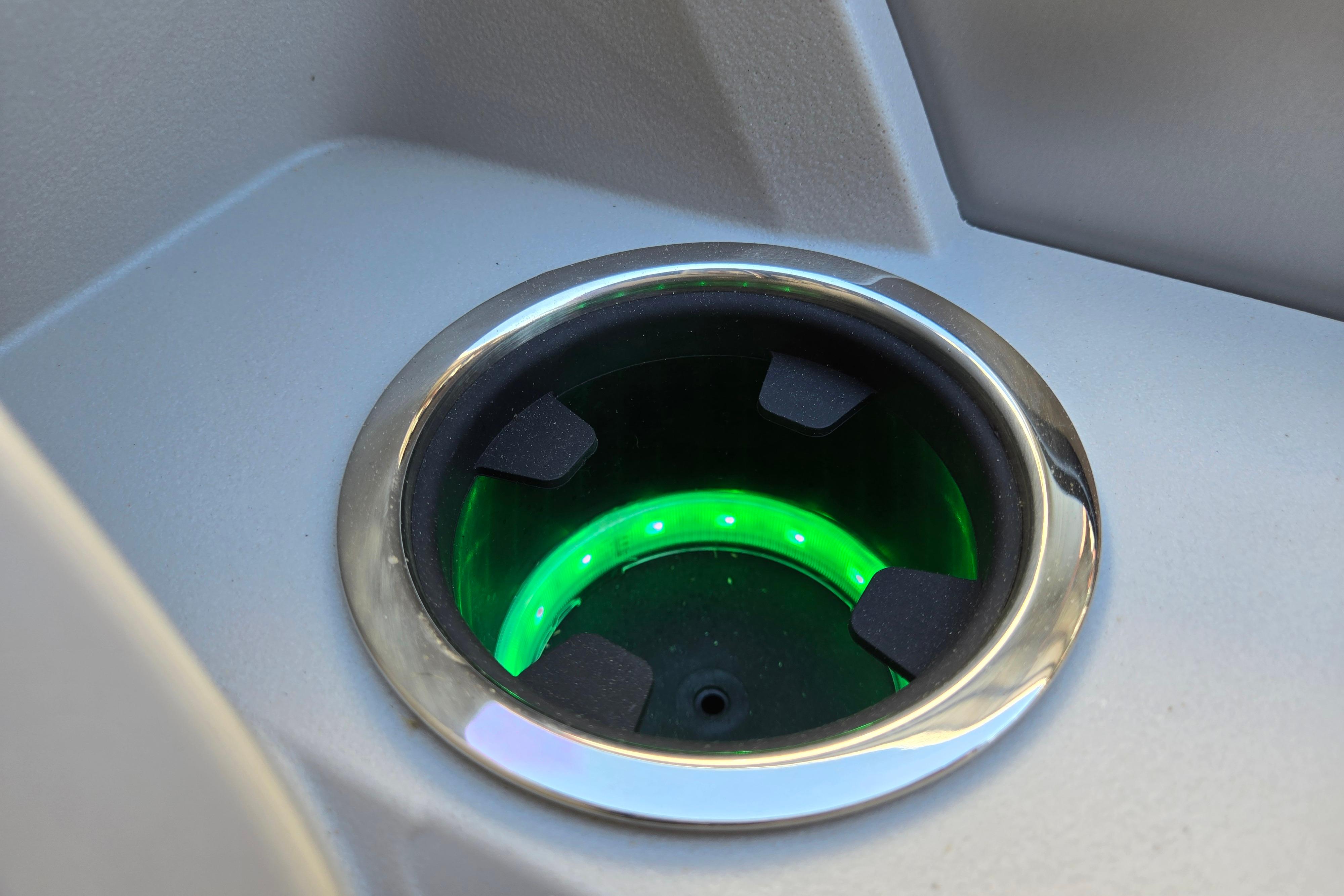 Illuminated cup holder on 2024 Godfrey Sweetwater 2486 SB boat, featuring green LED lighting.