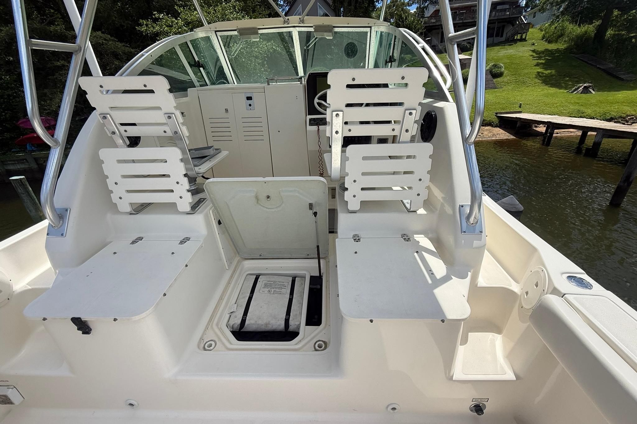 2003 Pursuit 2870 Walkaround boat interior with seating and storage compartments.