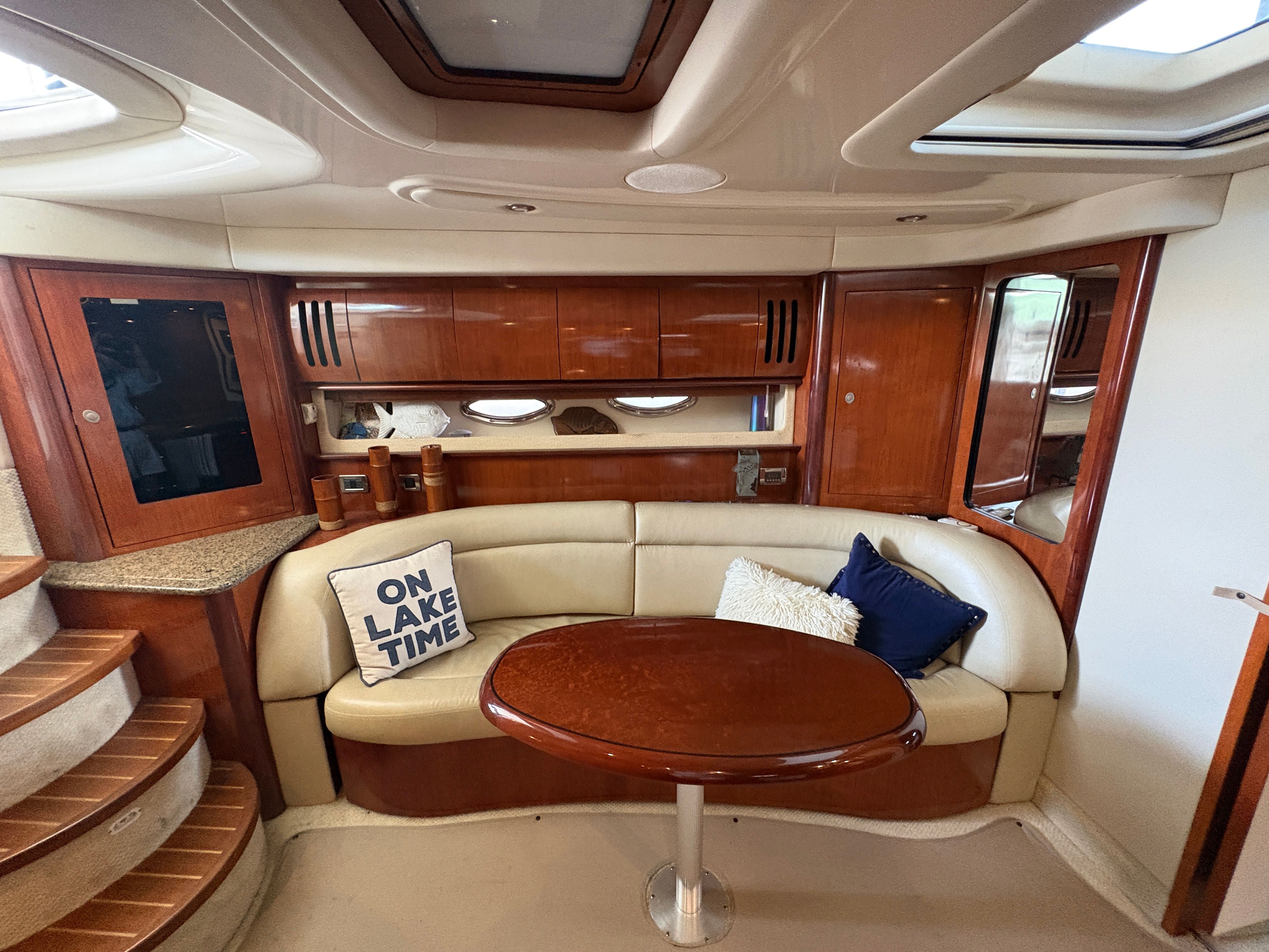 Interior of a 2005 Sea Ray 420 Sundancer yacht with sofa and table.