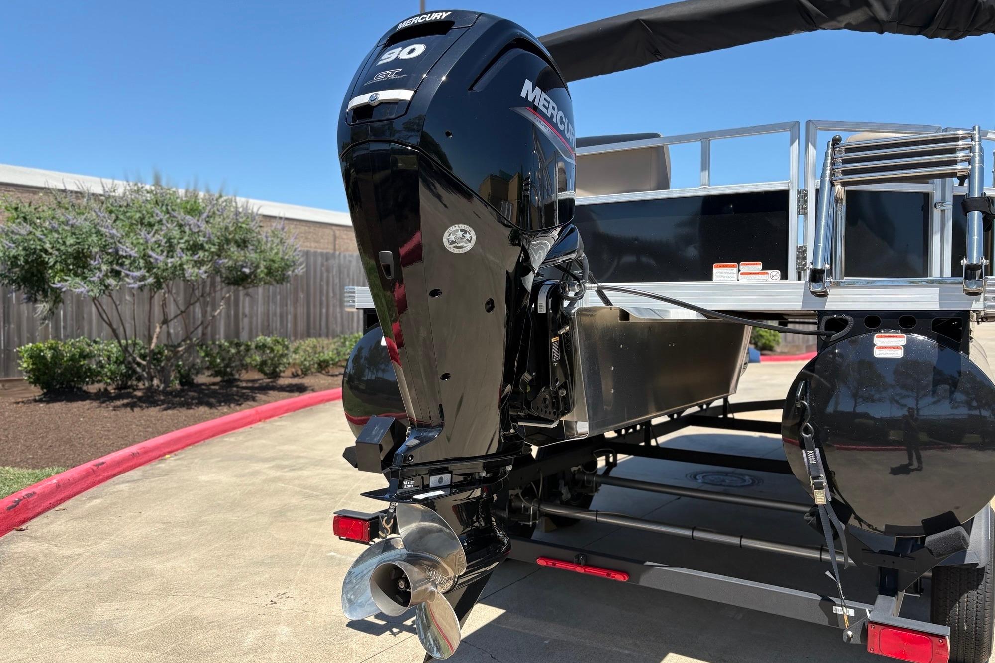 2024 Ranger Reata 200C boat with Mercury 90 engine, parked outdoors.