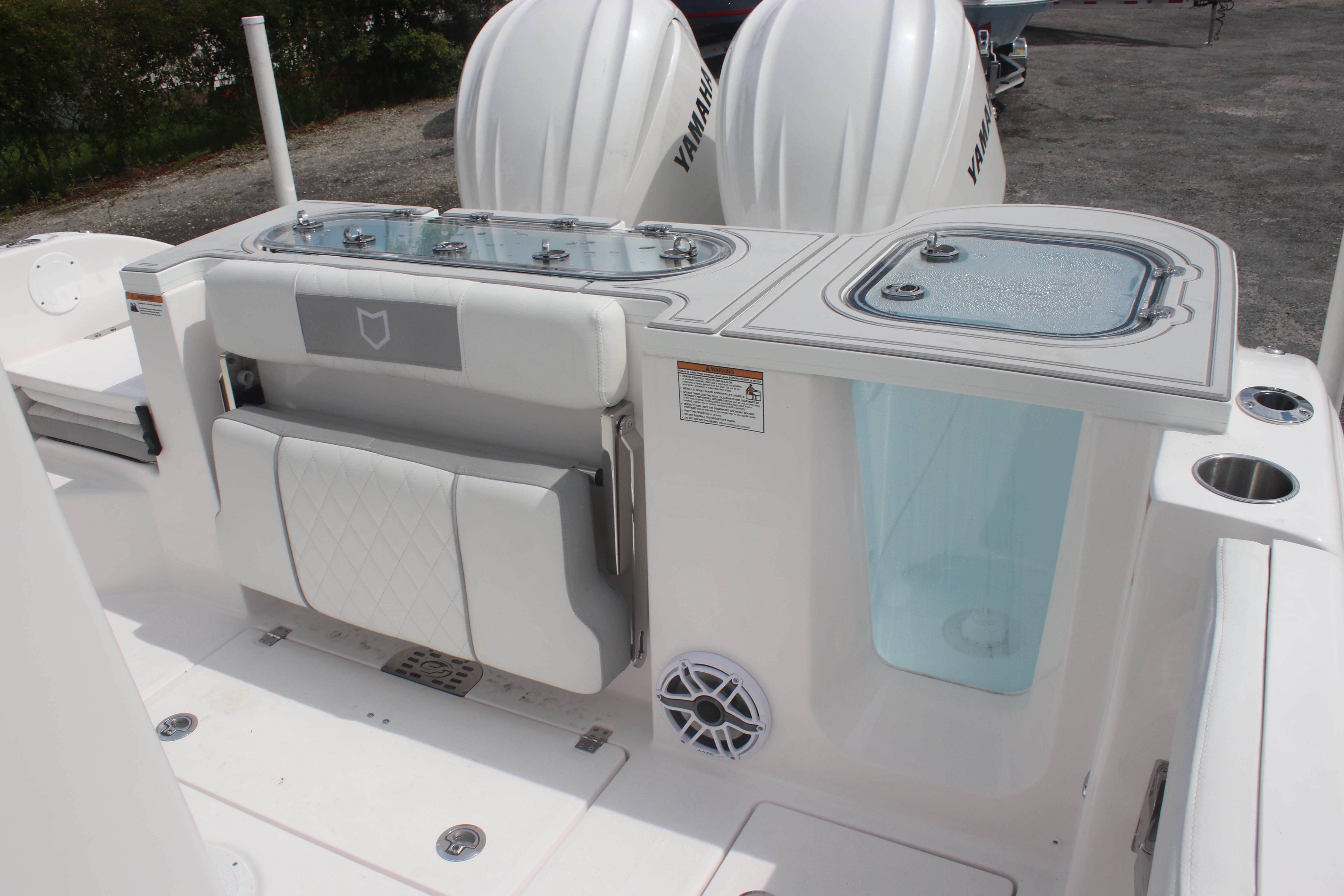 2026 Sea Fox 288 Commander boat interior with seating and storage compartments.