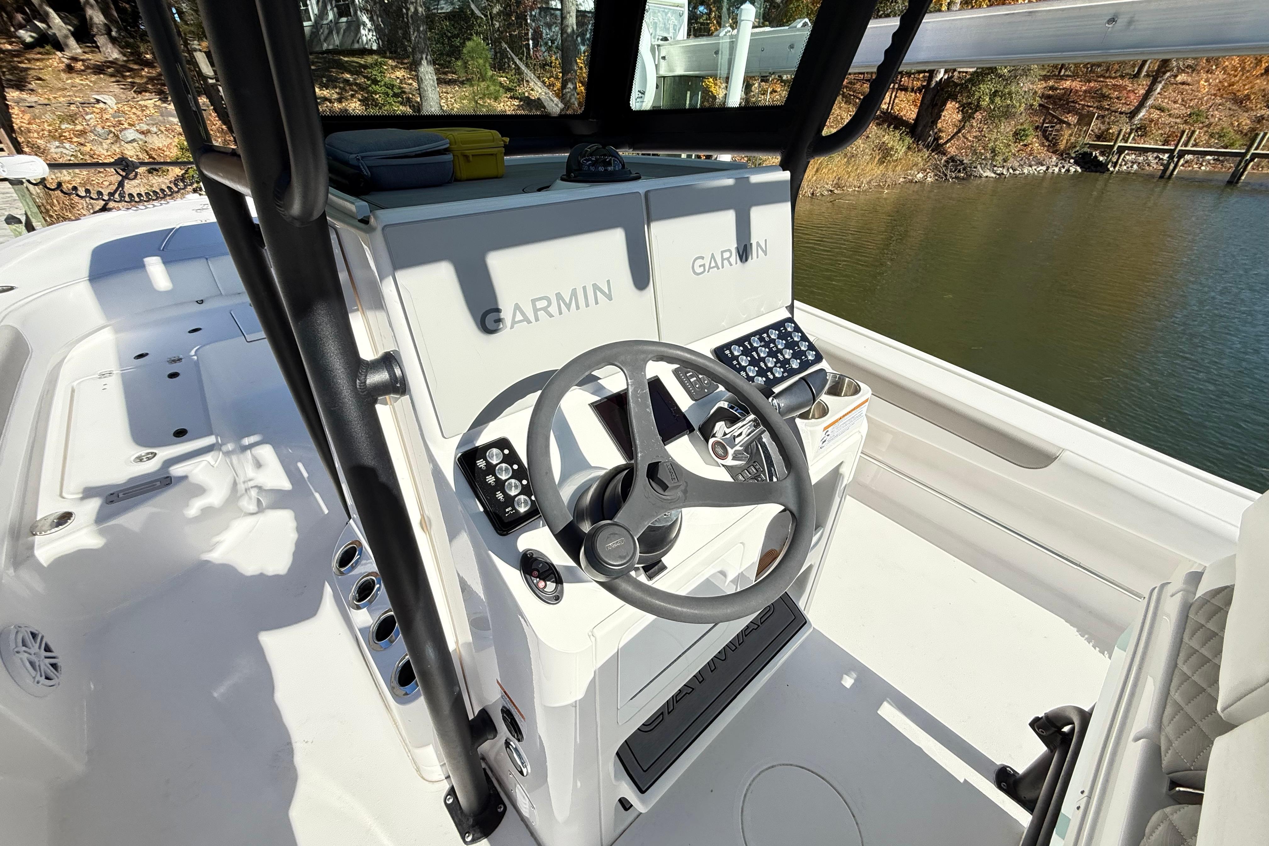 2023 Caymas 281 HB boat cockpit with Garmin navigation system and steering wheel.