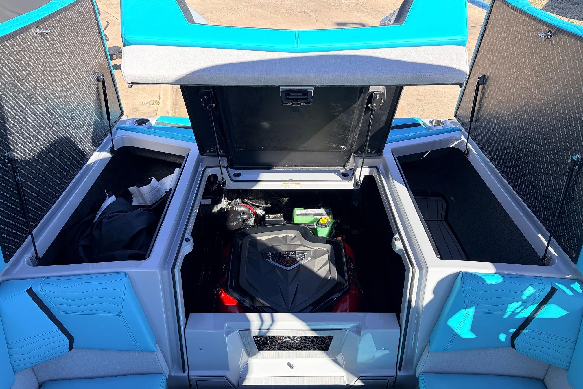 2026 Nautique Super Air Nautique G23 engine compartment with open storage hatches.