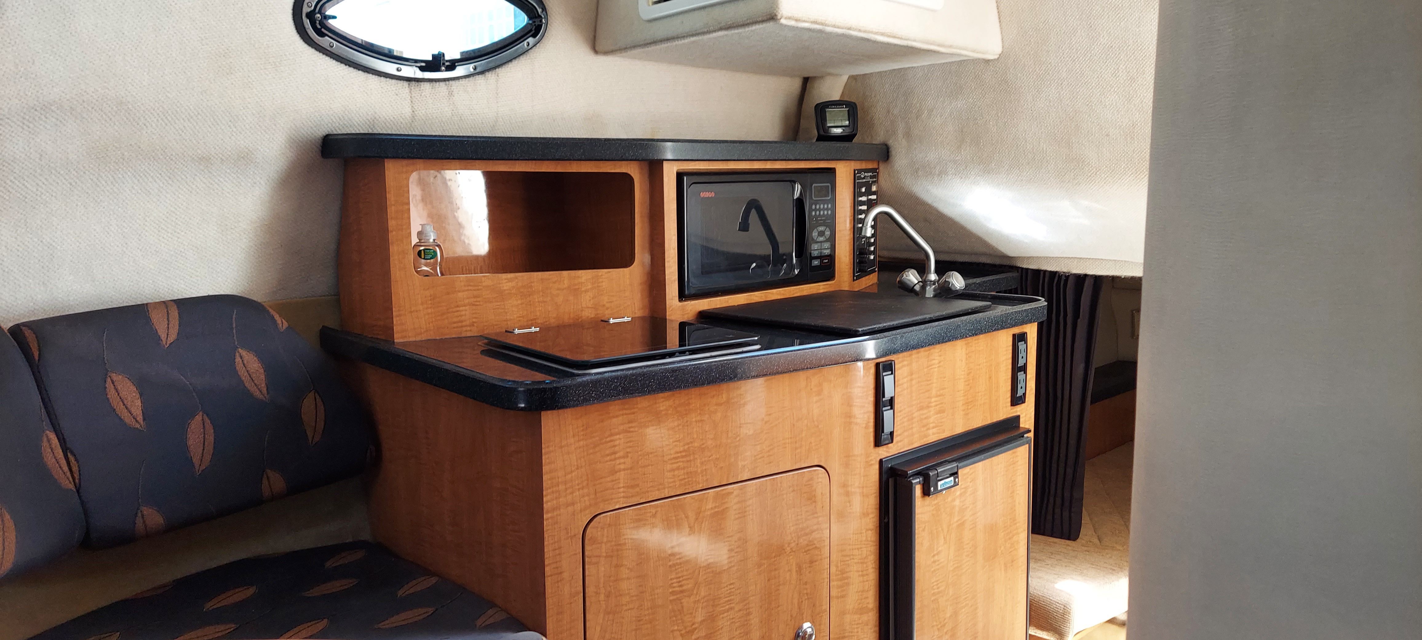 Interior of 2004 Regal Commodore 2465 yacht with kitchenette and seating area.