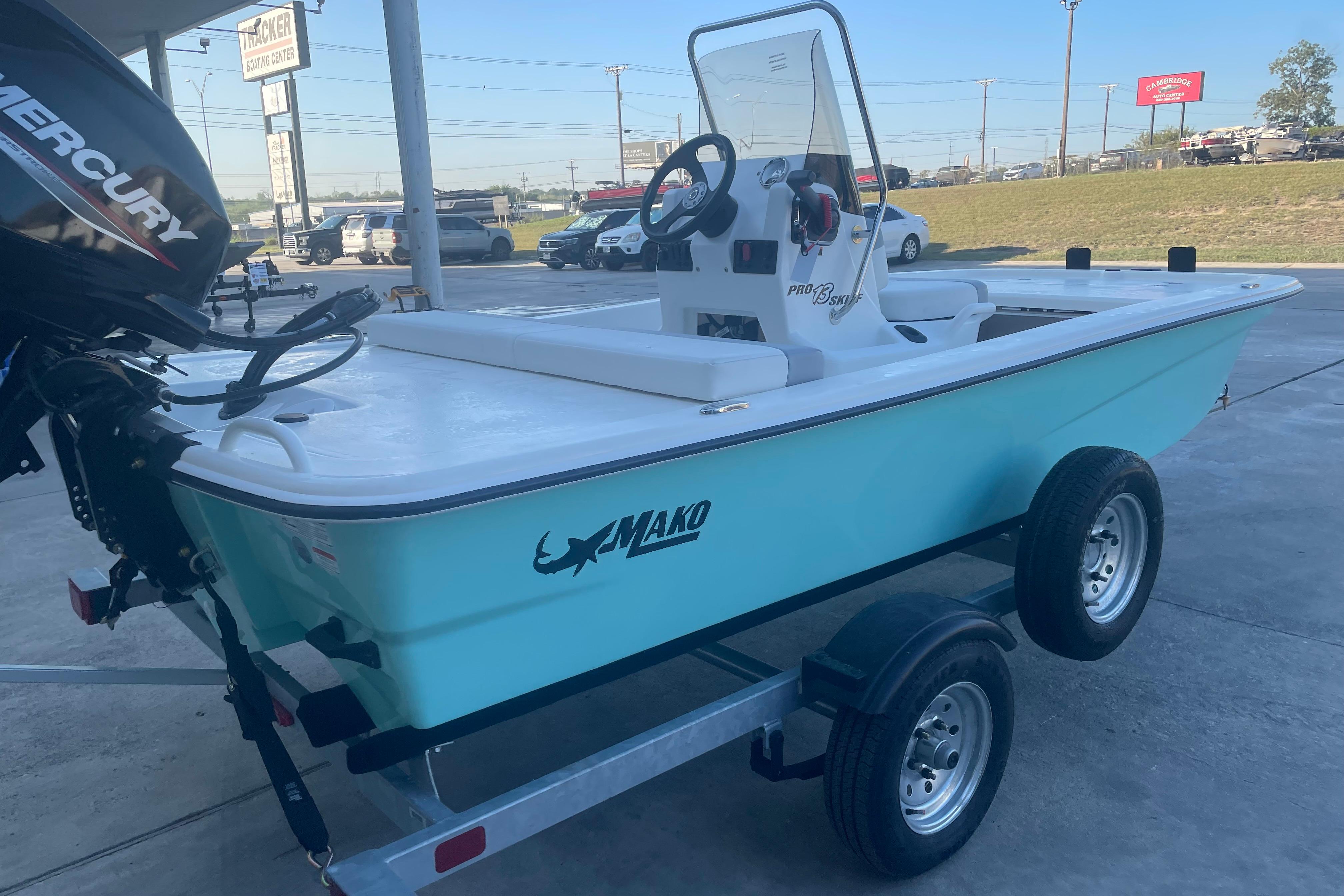 2026 Mako Pro Skiff 13 CC boat on trailer, parked outdoors.