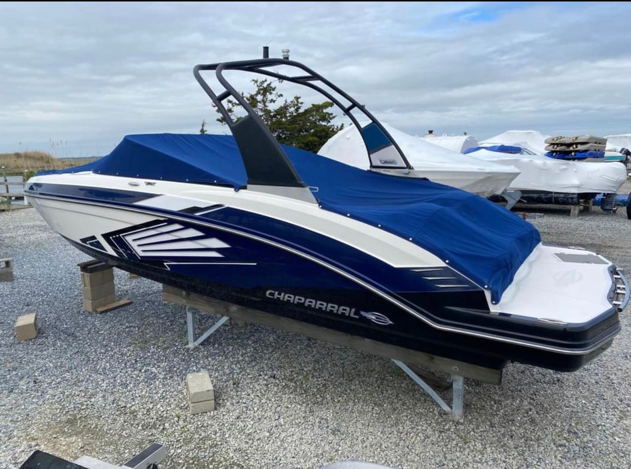 A 2016 Chaparral Vortex 243 VRX boat is on a stand on land.