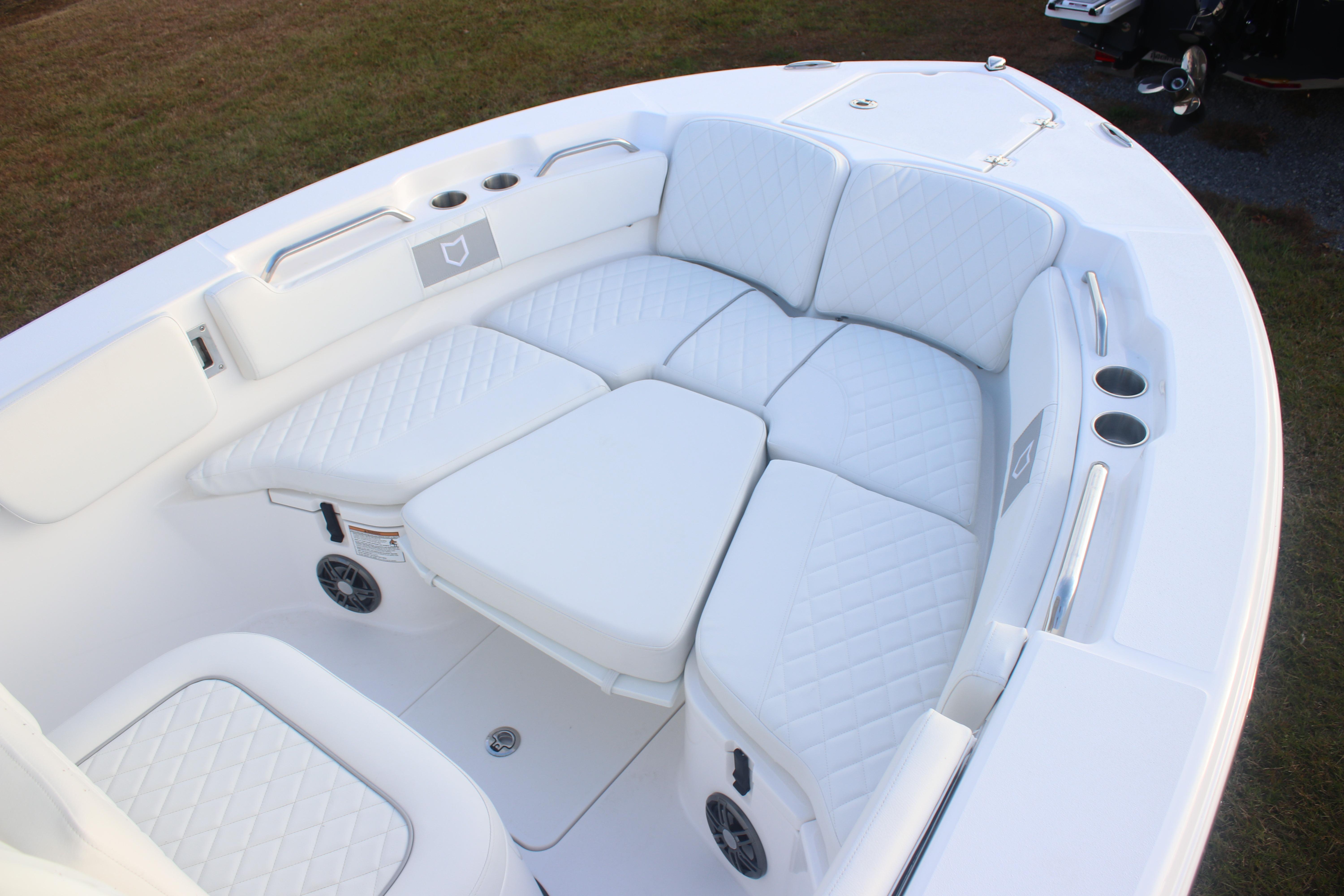 2026 Sea Fox 228 Commander boat with luxurious white seating and cup holders.