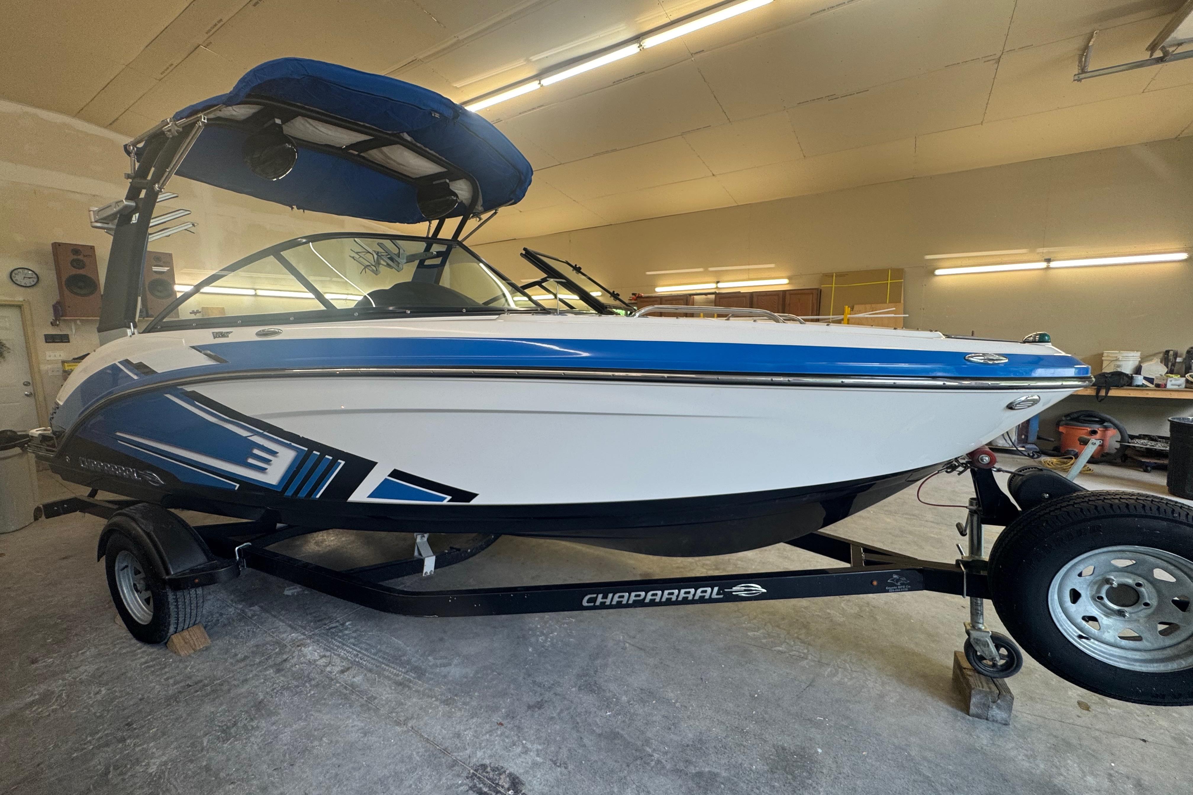 2017 Chaparral Vortex 203 VRX boat in a garage, featuring blue and white design.