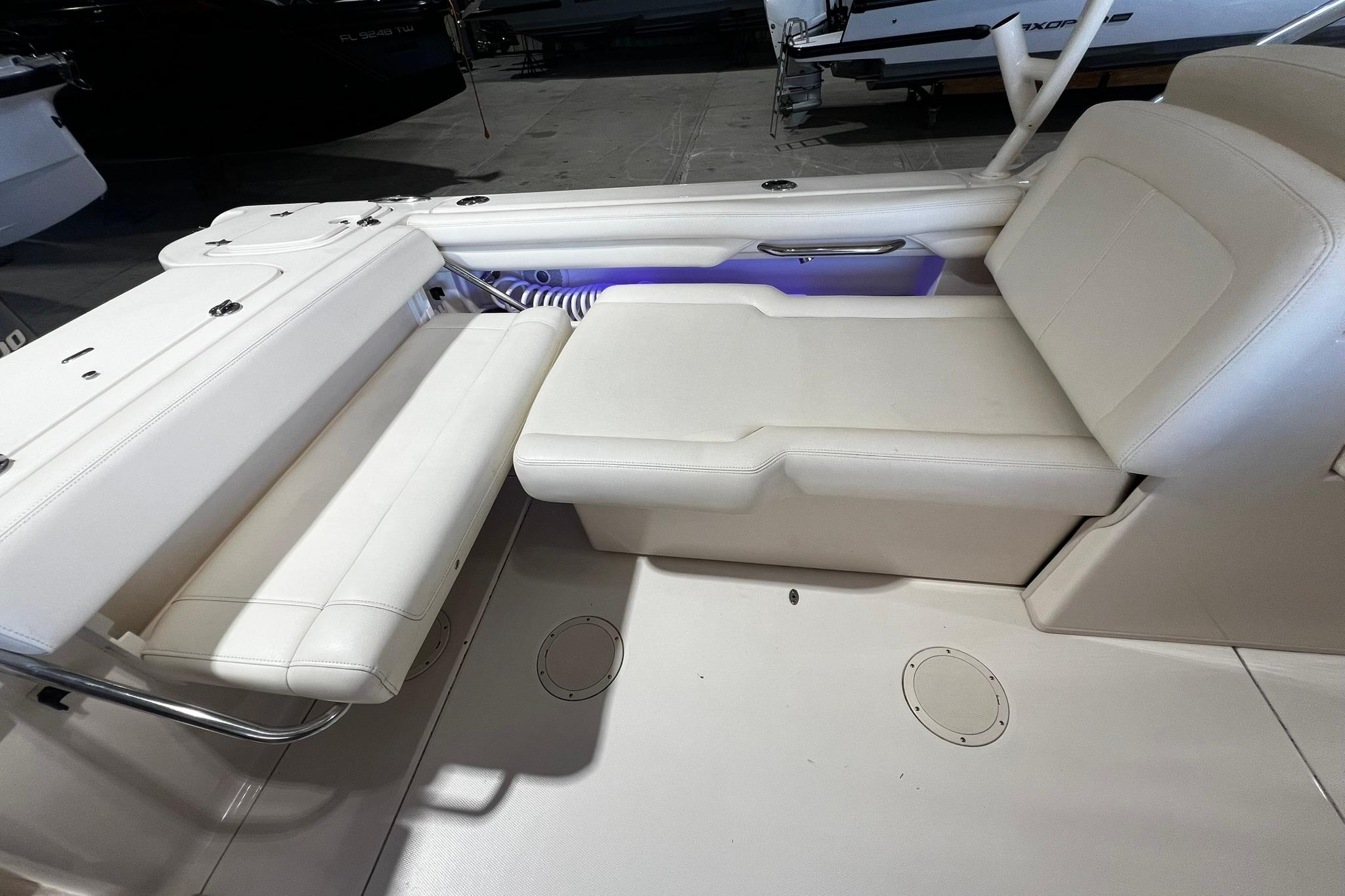 2014 Grady-White Freedom 275 boat interior with white seating and storage compartments.
