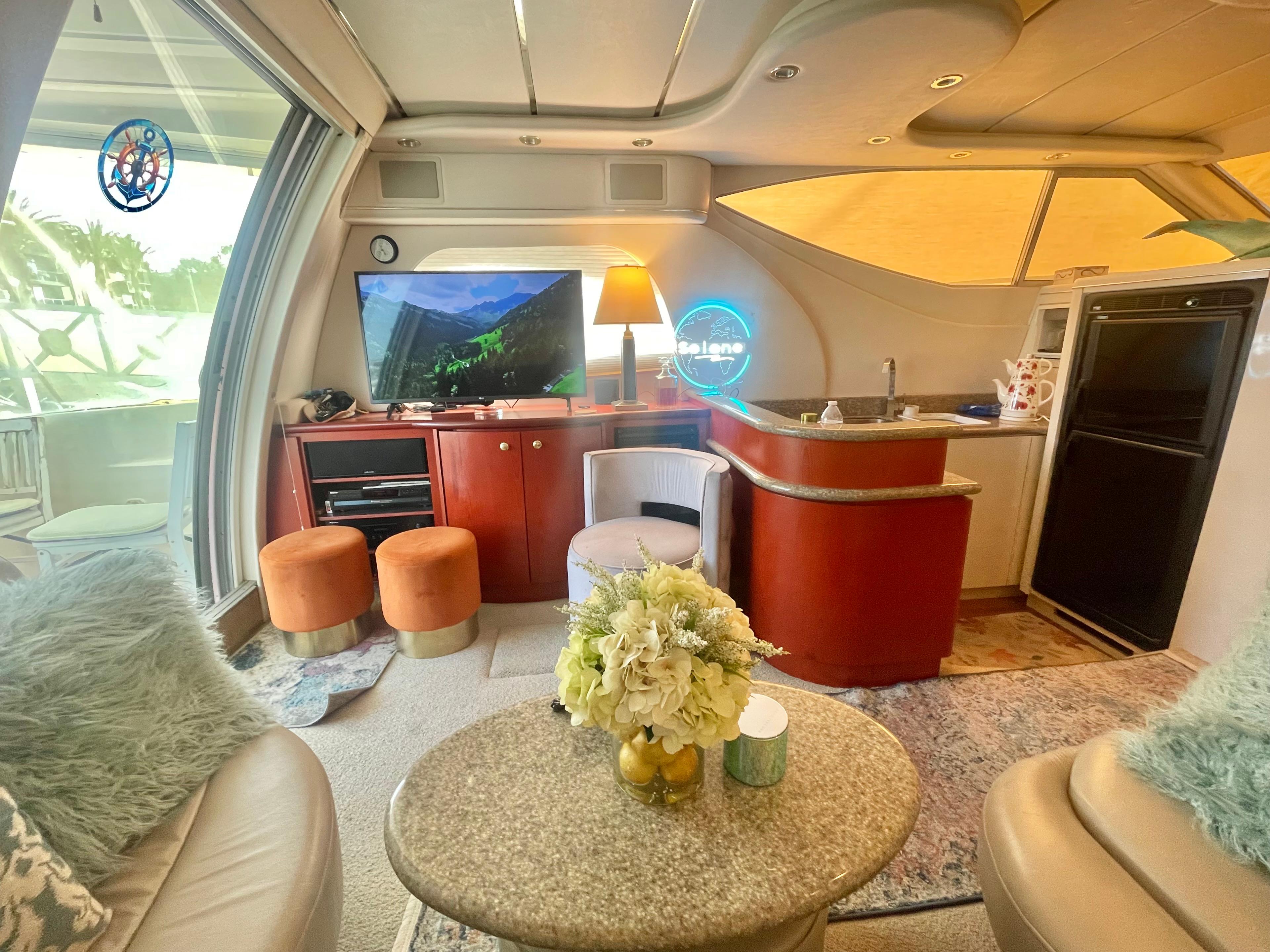 Luxurious interior of 1998 Maxum 4100 SCA yacht with modern decor and cozy seating.
