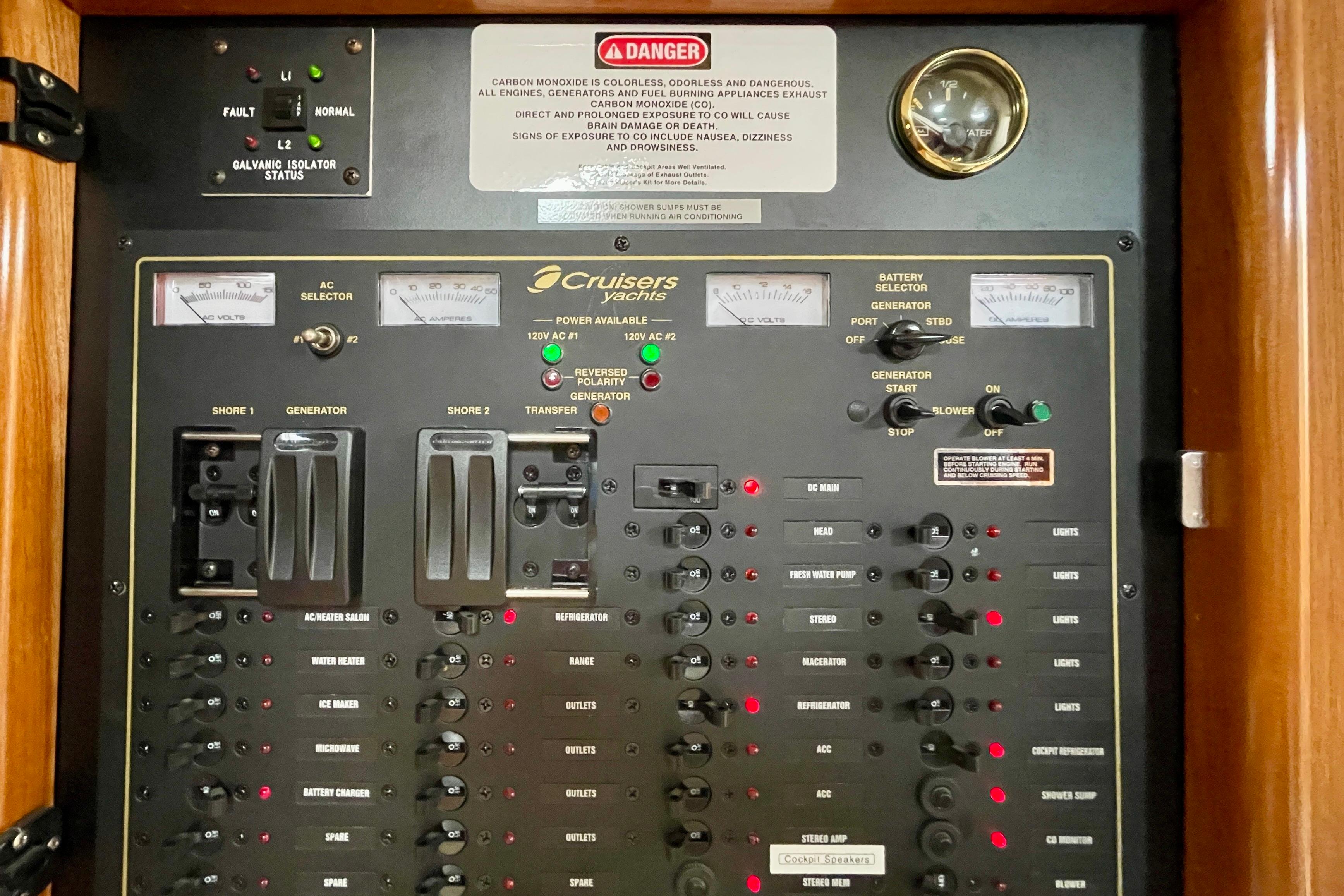 Electrical control panel of 2004 Cruisers Yachts 320 Express, featuring various switches and gauges.