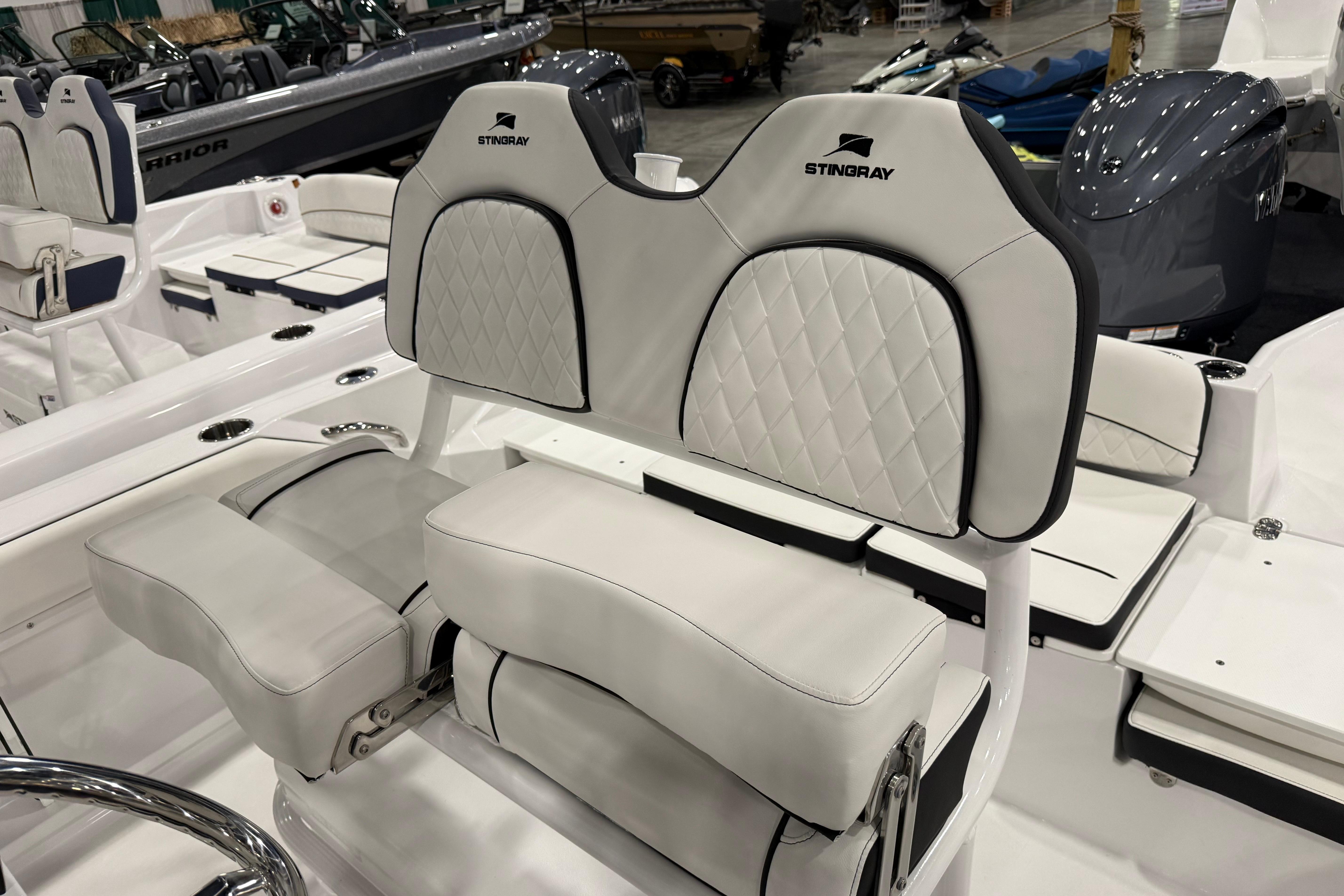 2026 Stingray 216 CC boat interior with white cushioned seating and elegant design.