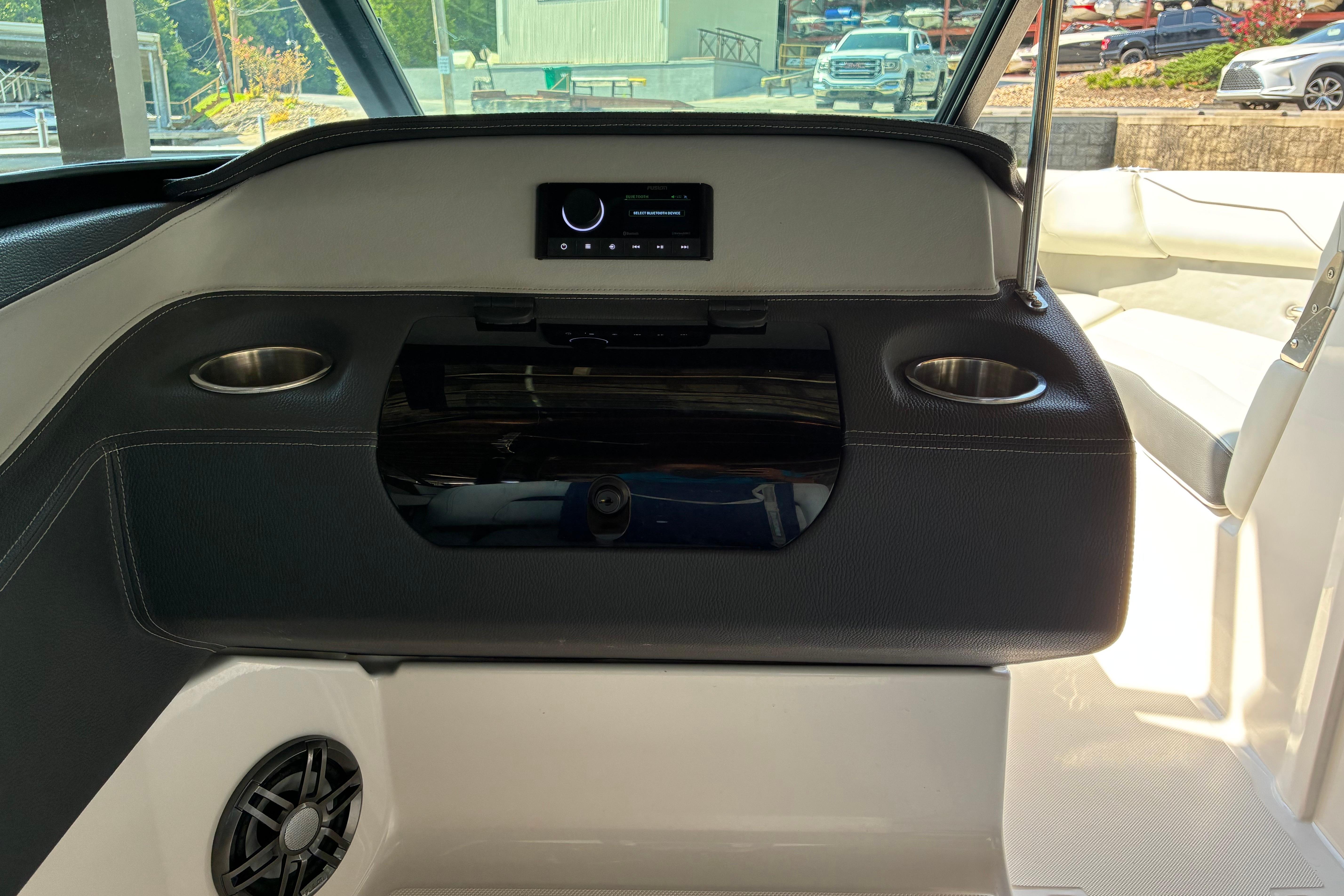 2025 Regal LS2 boat interior with dashboard, cup holders, and speaker.