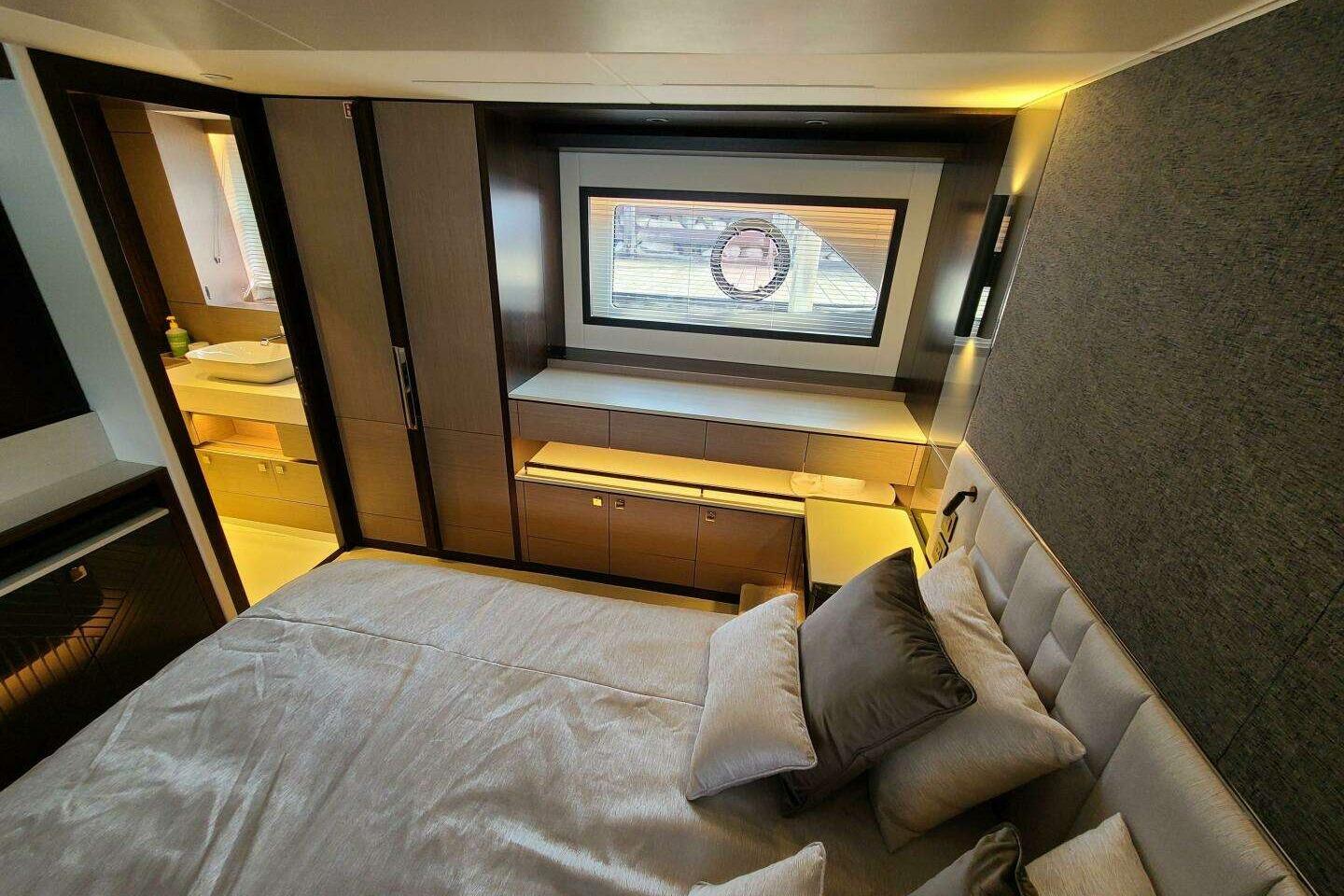 Luxurious bedroom interior of 2023 Sunseeker Manhattan 68 yacht, featuring modern design and elegant furnishings.