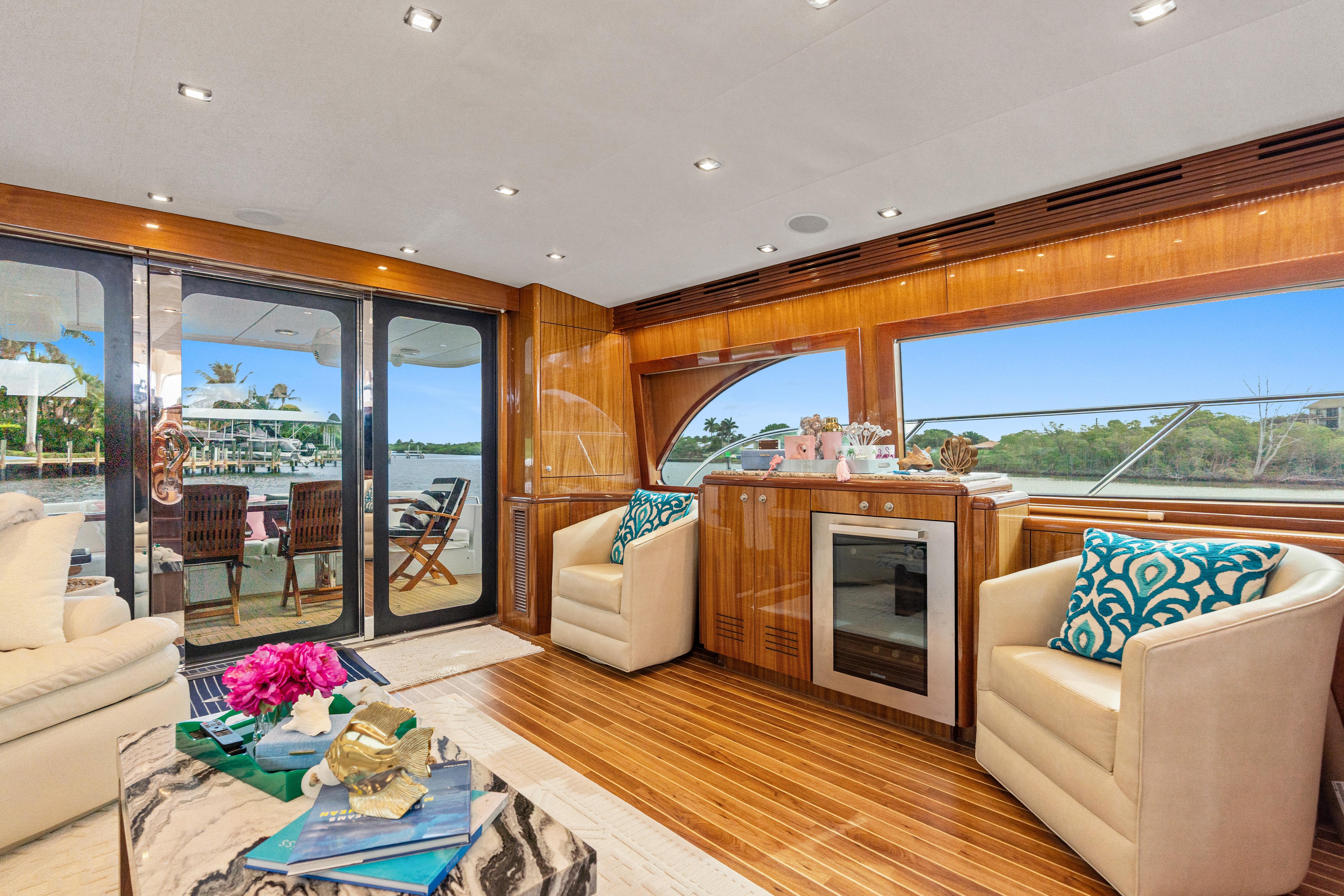 Luxurious interior of 2008 Hatteras 64 Motor Yacht with elegant seating and scenic views.