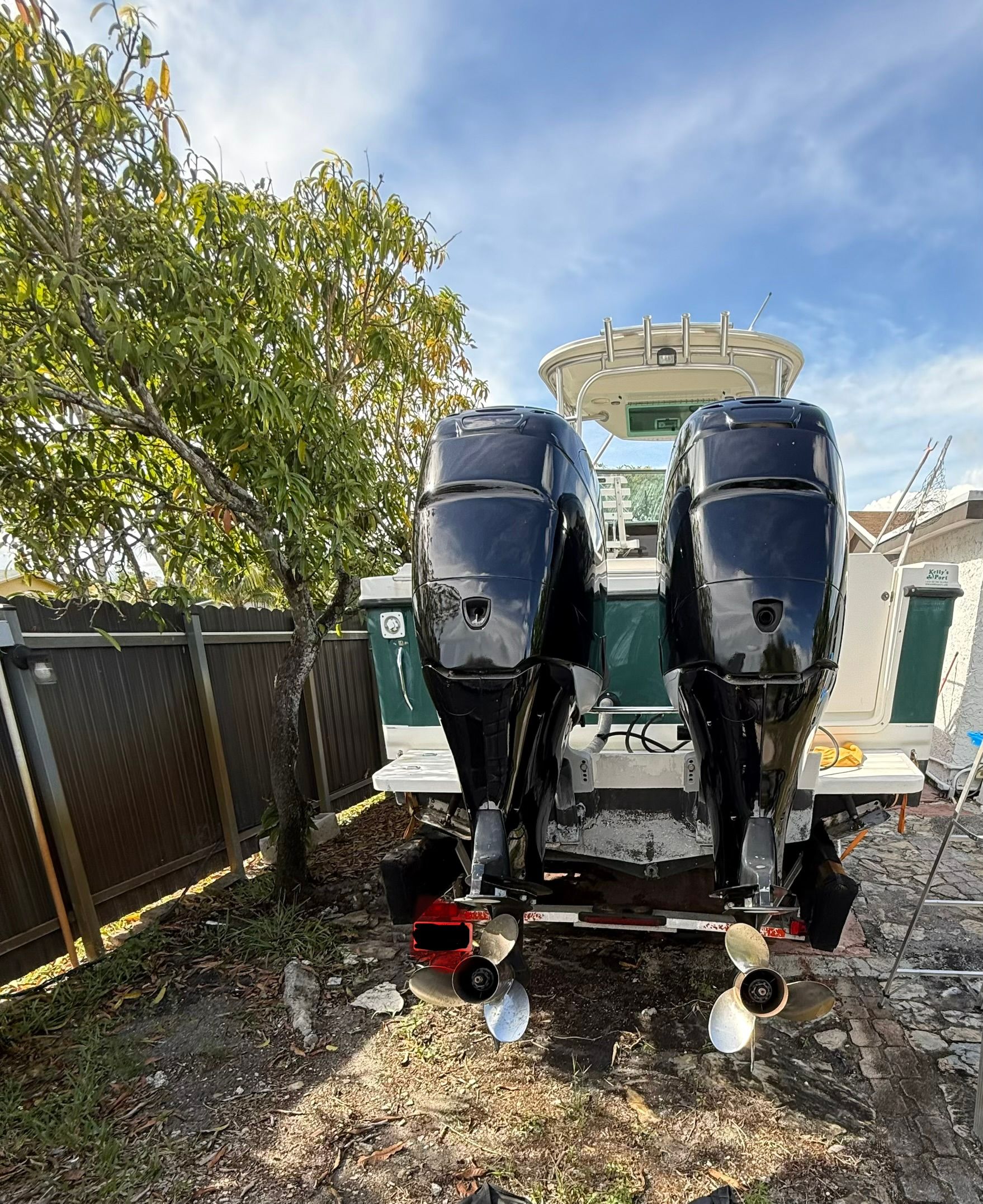 2005 Trophy 2902 Walkaround with dual outboard motors in a backyard.