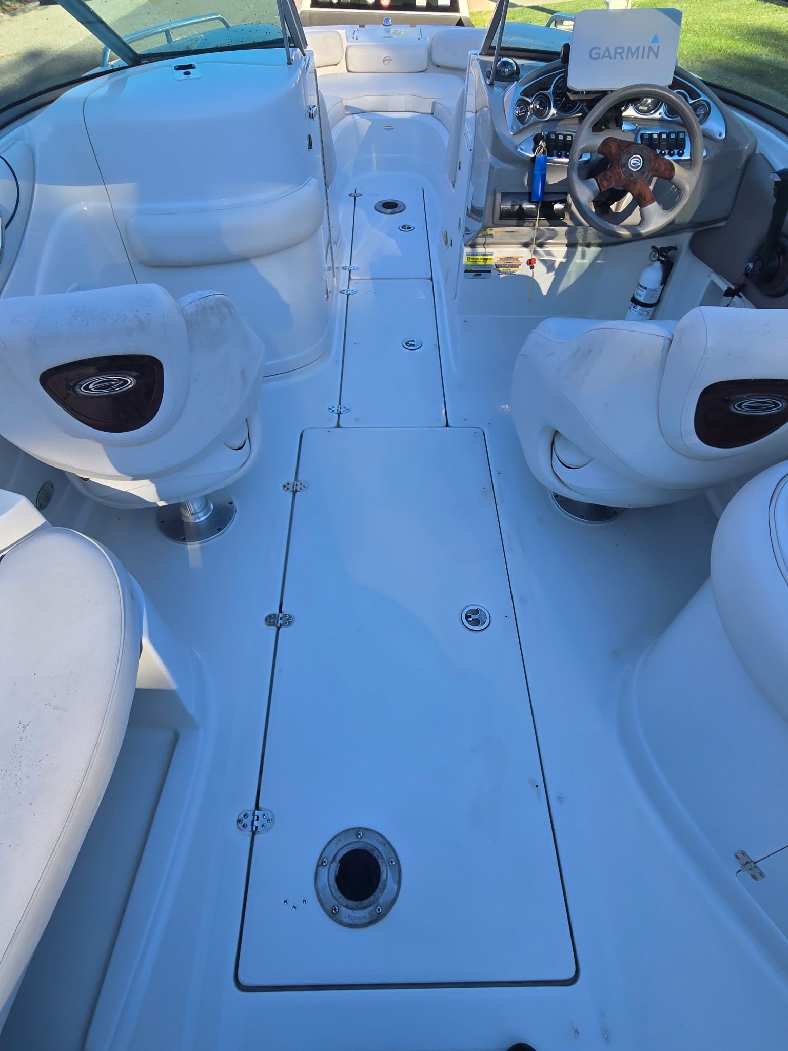 The image shows the cockpit of a 2005 Crownline 240 EX boat with a Garmin navigation system.