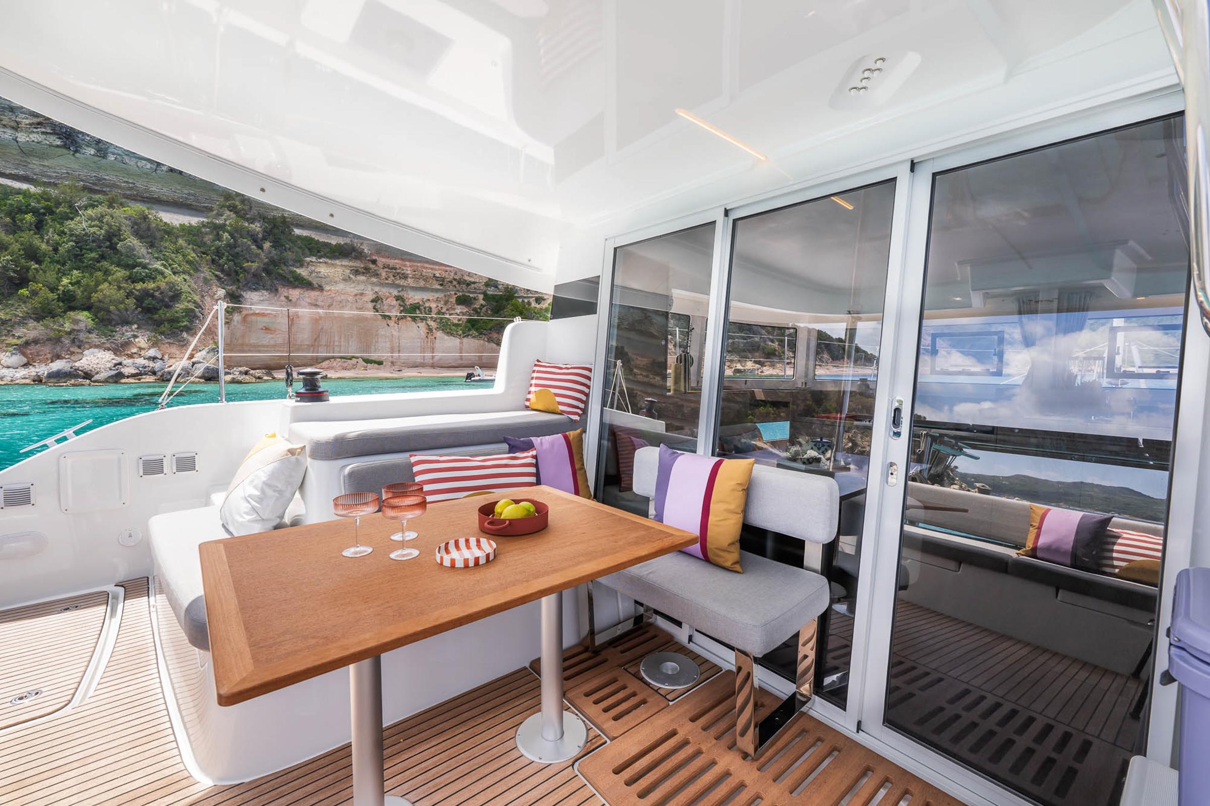 Luxurious Lagoon 38 yacht interior, featuring a stylish dining area with scenic ocean views.