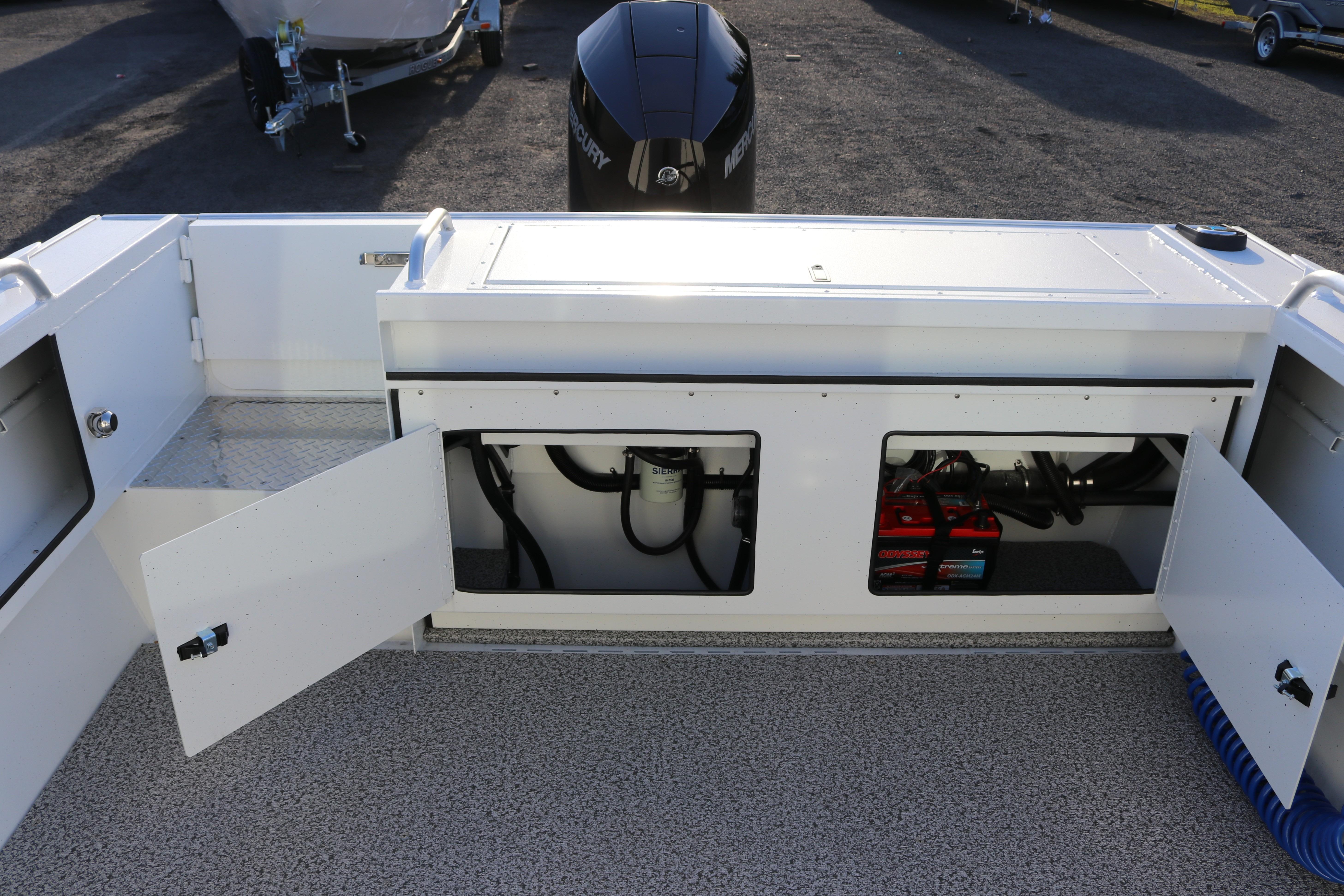 2026 Alumaweld Intruder Outboard 22 boat interior with open storage compartments and visible engine components.