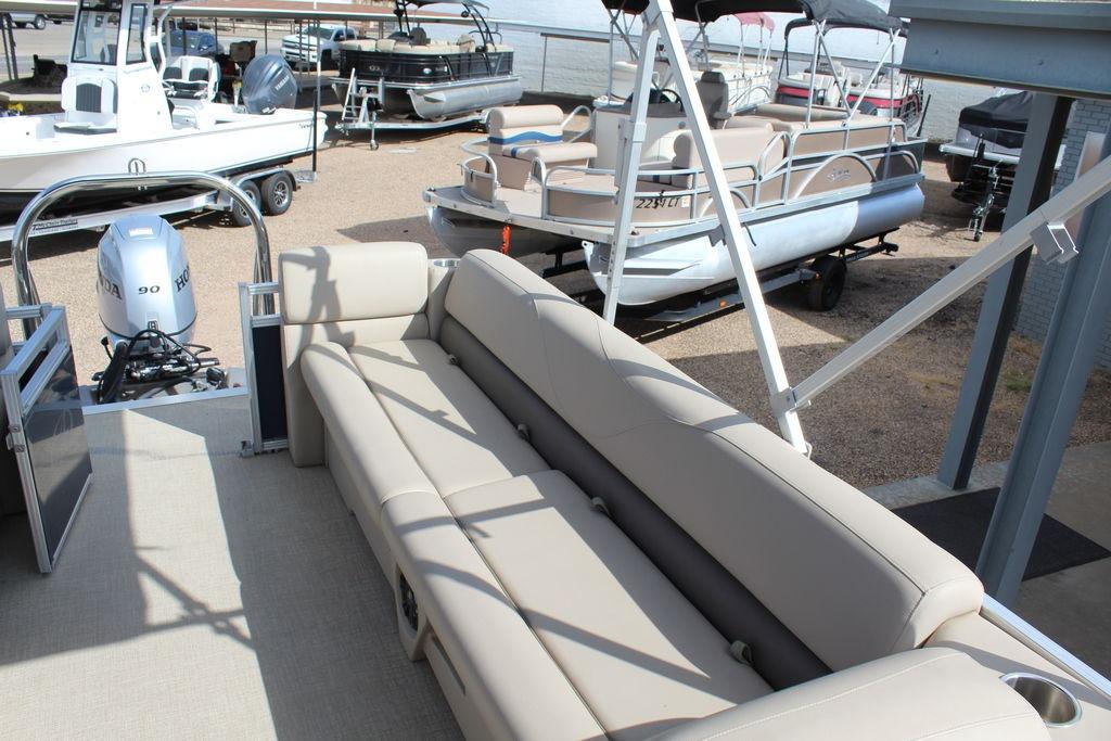 2021 Avalon VLS Quad Lounge 22 FT pontoon boat with beige seating and Honda outboard motor.