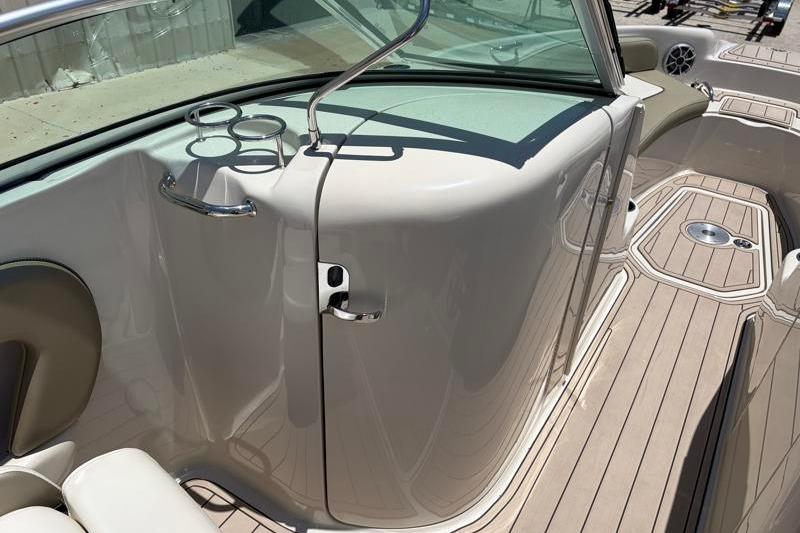 2007 Sea Ray 240 Sundeck interior with beige seating and cup holders.