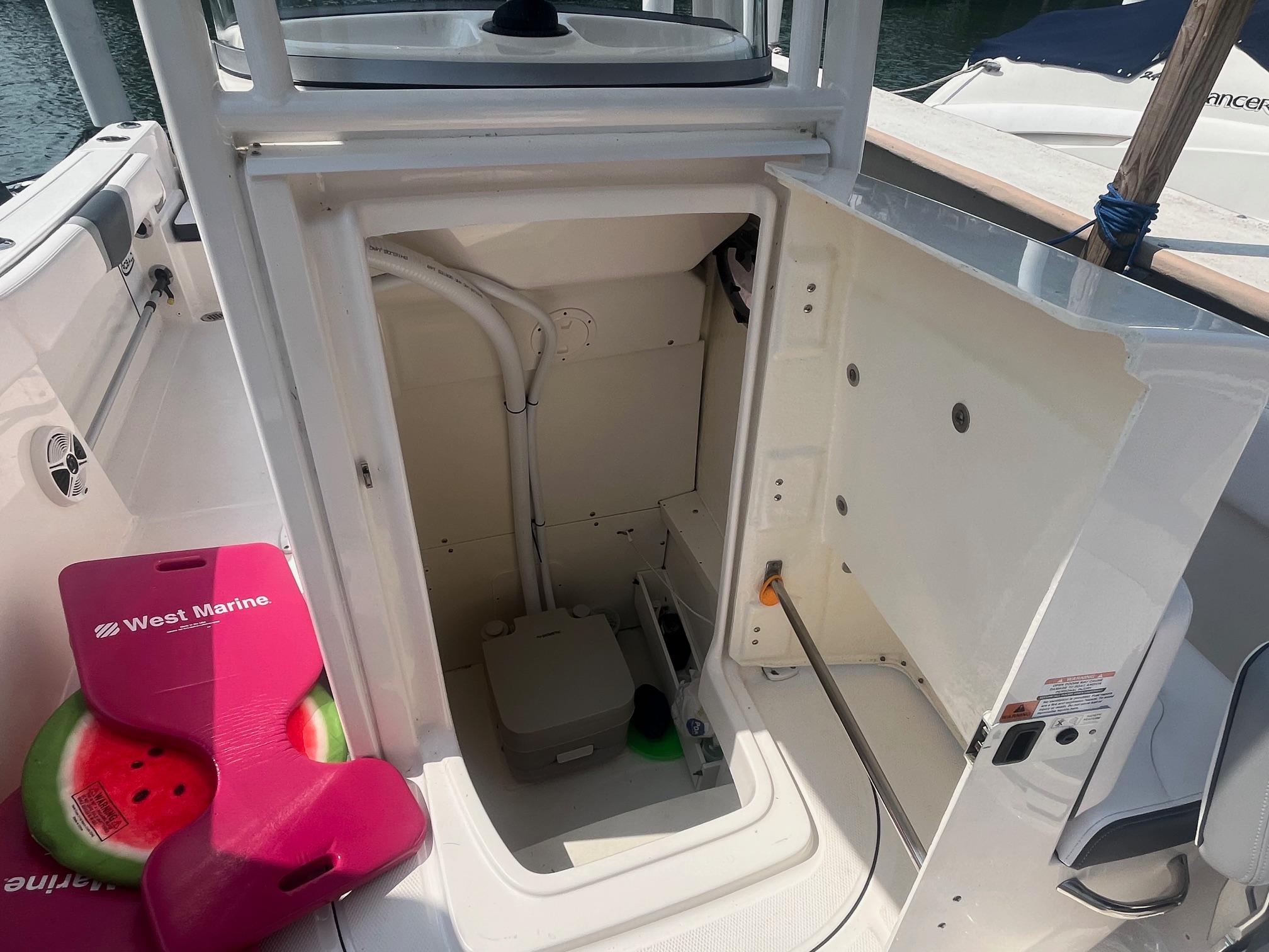2020 Robalo R230 Center Console boat storage compartment with marine equipment and accessories.