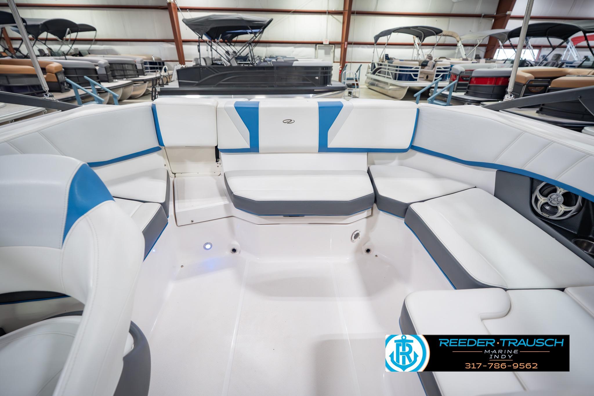 2015 Regal 2000 ESX Bowrider interior with white and blue seating in showroom.