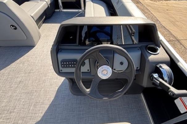 2026 Sun Tracker Party Barge 18 DLX steering console with modern controls and seating.