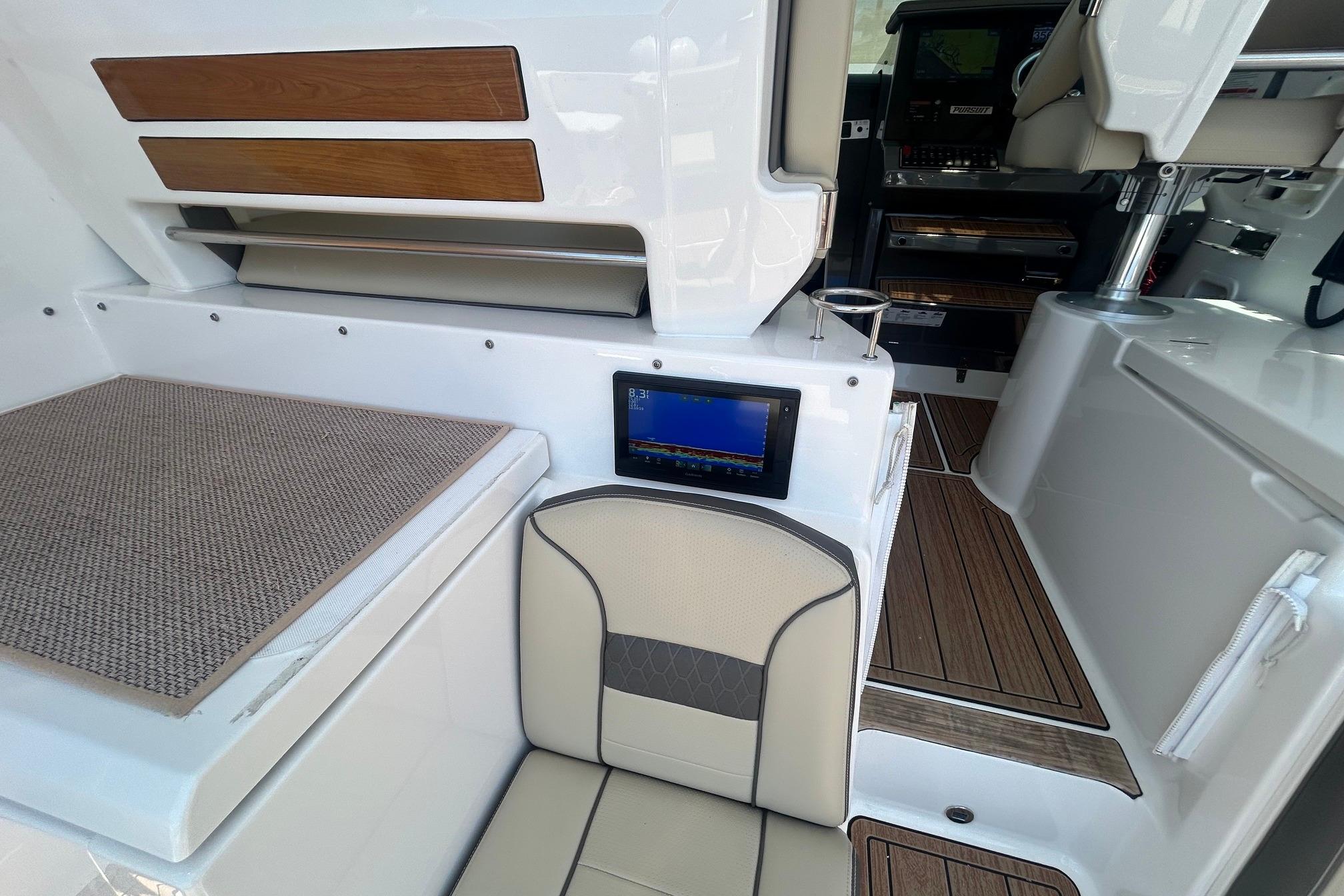 2019 Pursuit OS 355 Offshore interior with seating and navigation display.